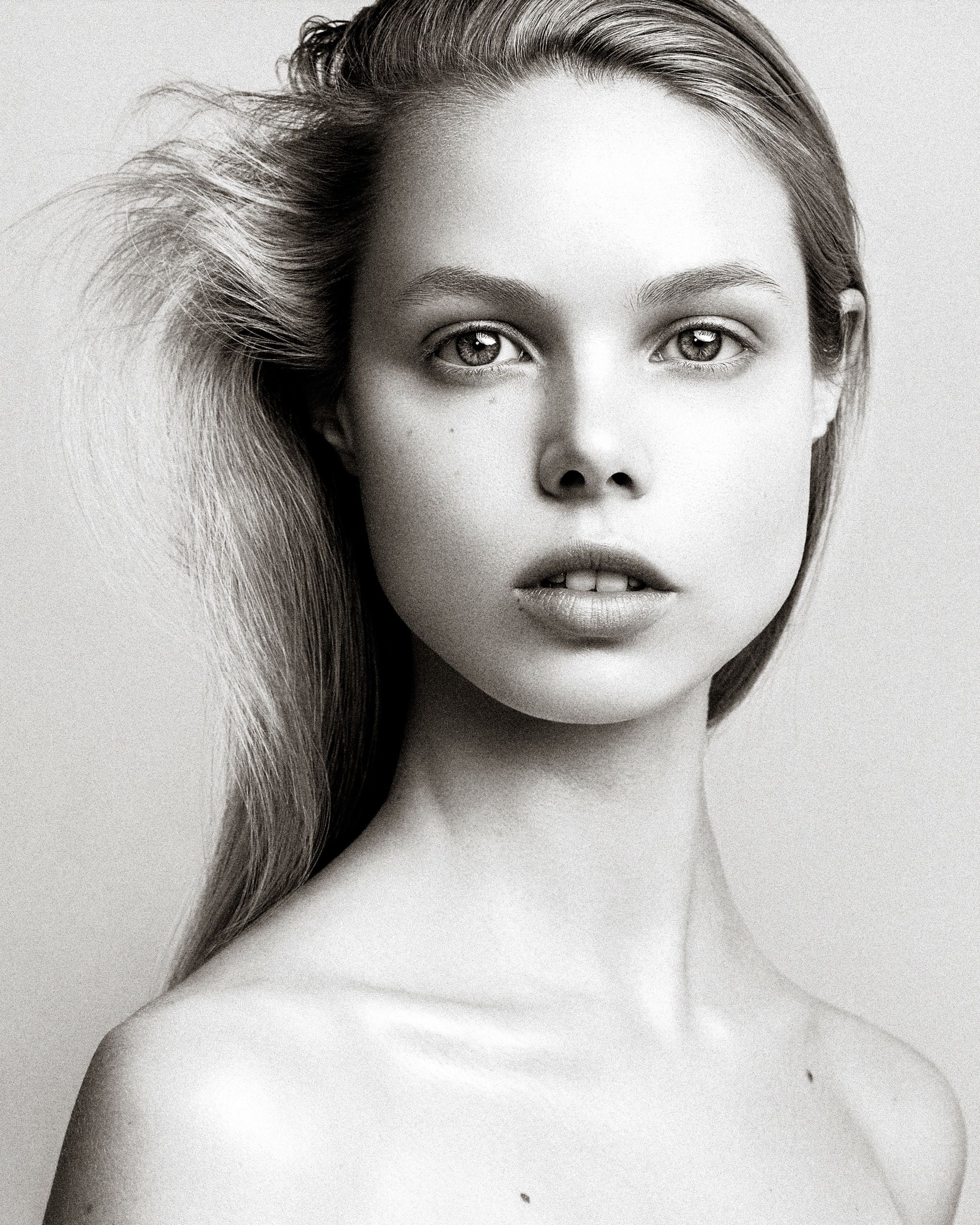 Black and white artistic portrait series showing dramatic lighting and ethereal expressions against a light background.