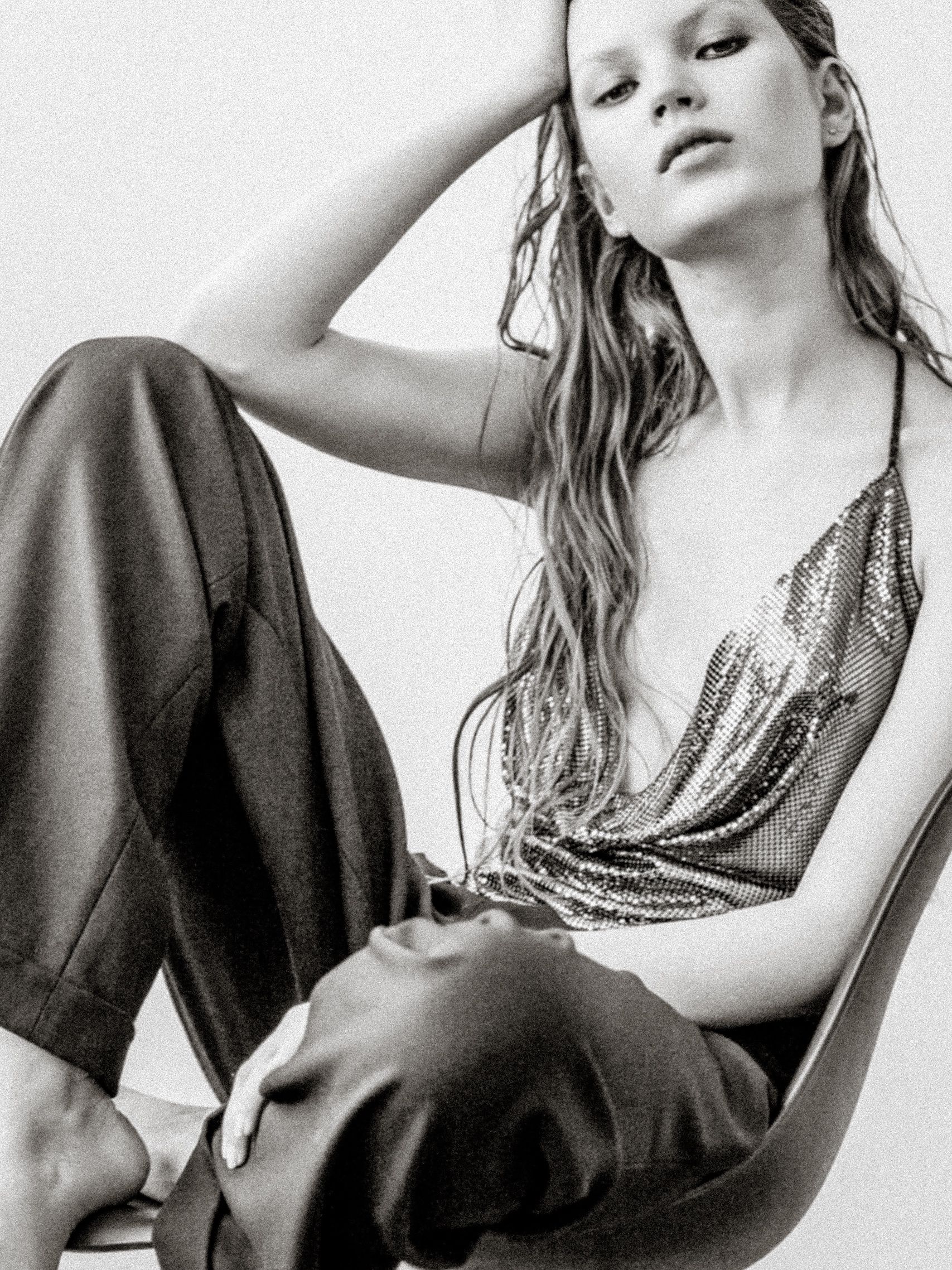 Artistic black and white fashion photo series showing model in contrasting dark and light outfits against white backdrop.