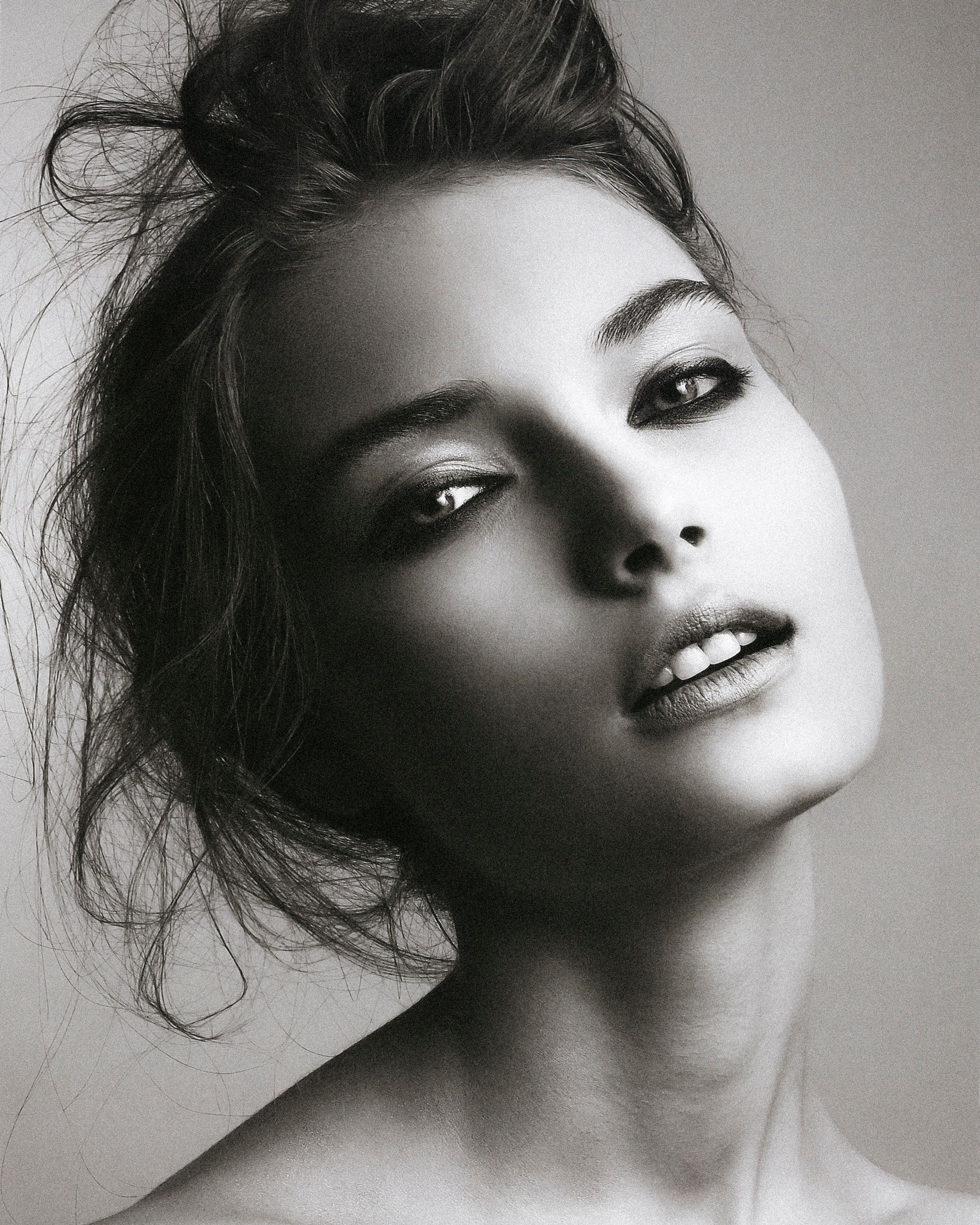 A dramatic black and white portrait series showing tilted angles and moody lighting effects.