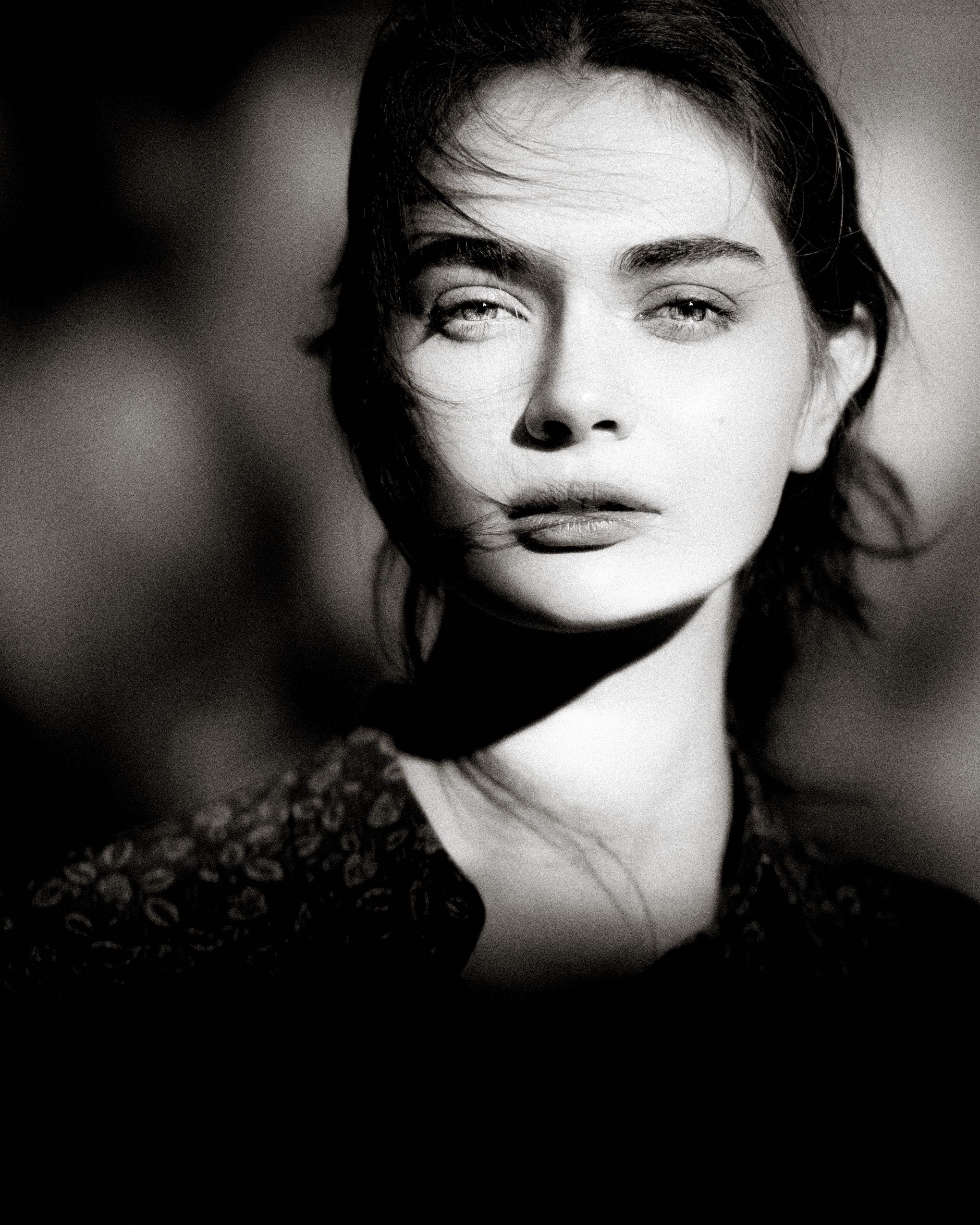 A series of dramatic black and white portraits in film noir style with moody lighting and shadows.