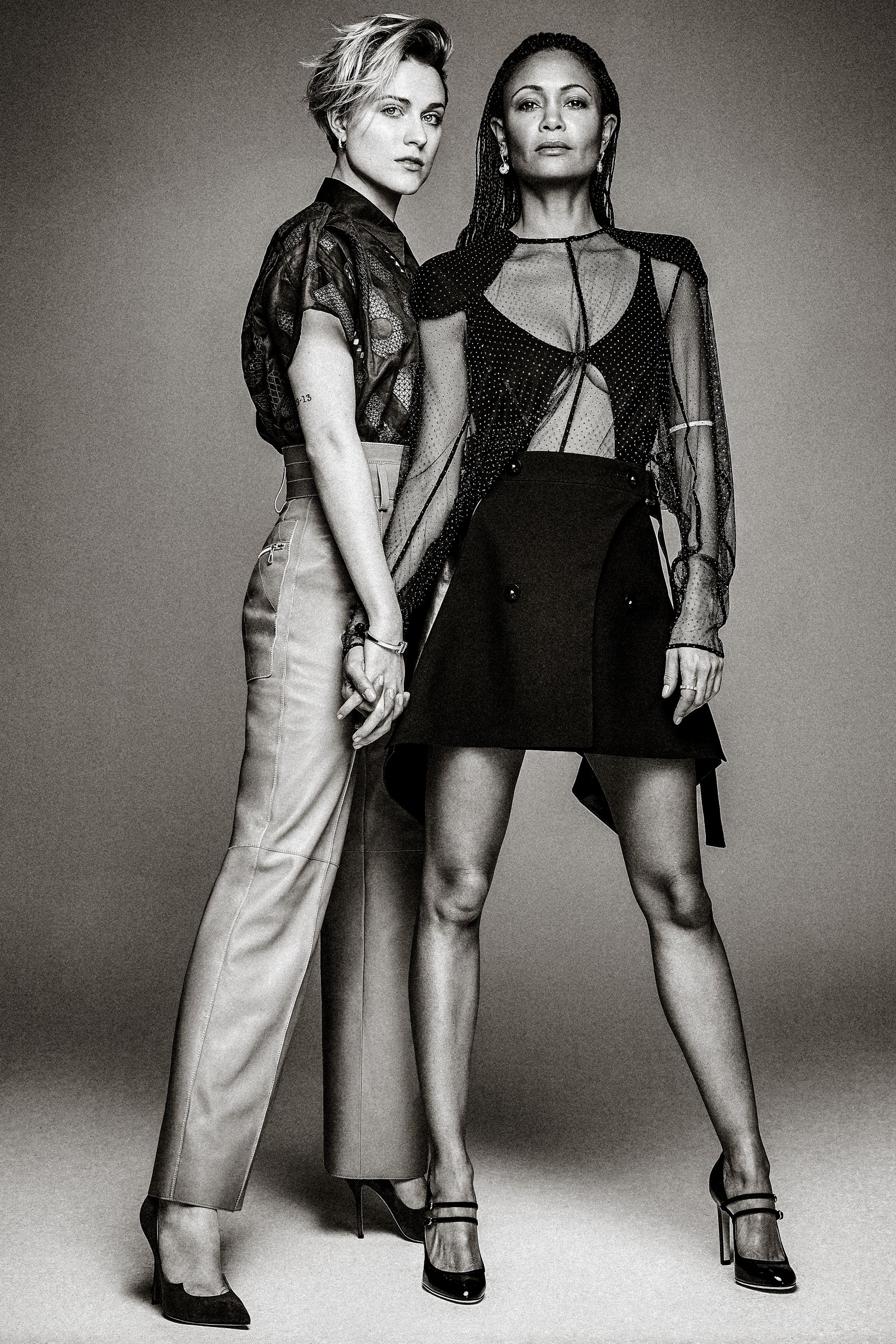 Black and white fashion photograph series showing models posing in contrasting light and dark outfits against a plain backdrop.