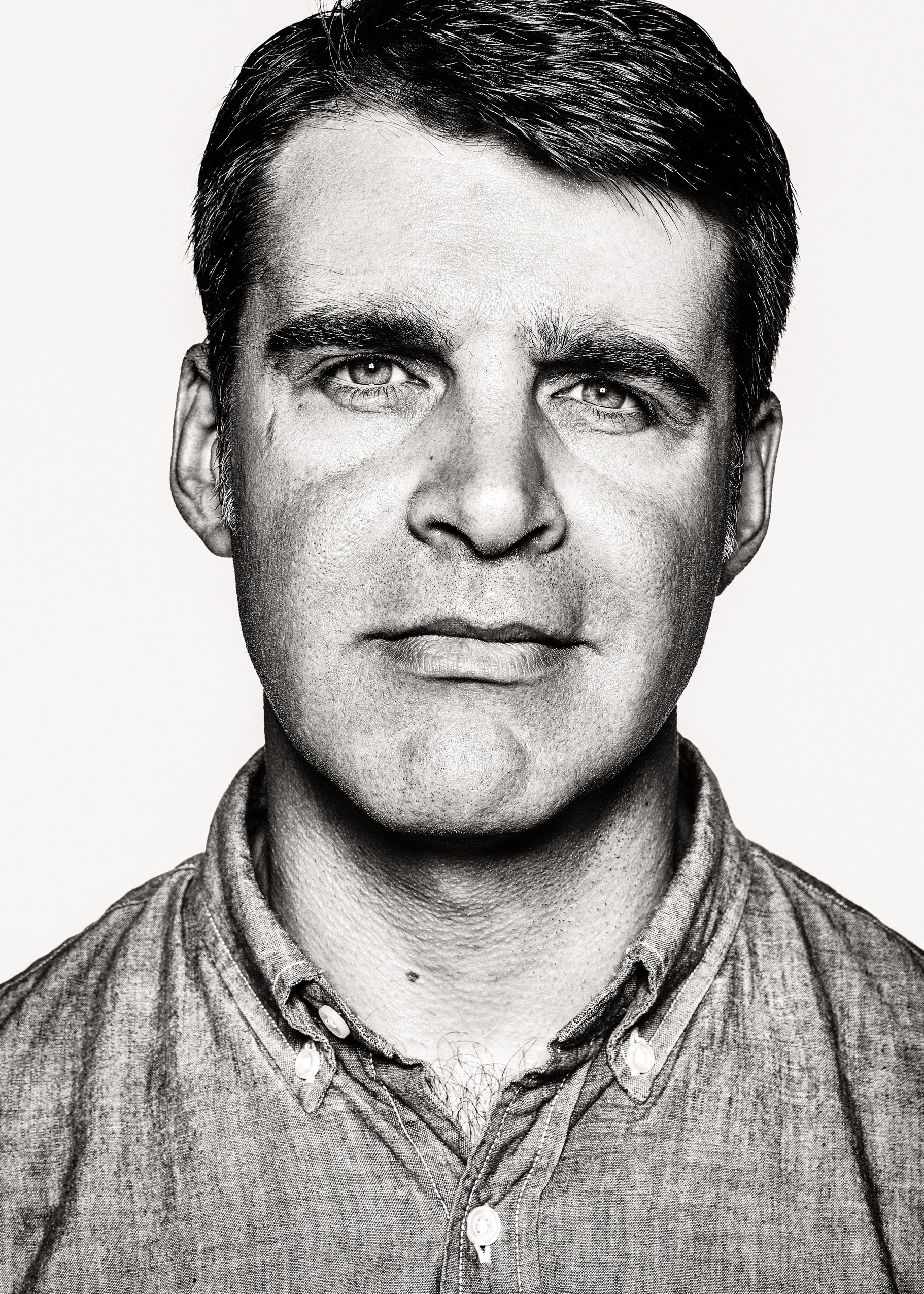 Black and white portrait series showing the same person's face in four similar poses against a white background.