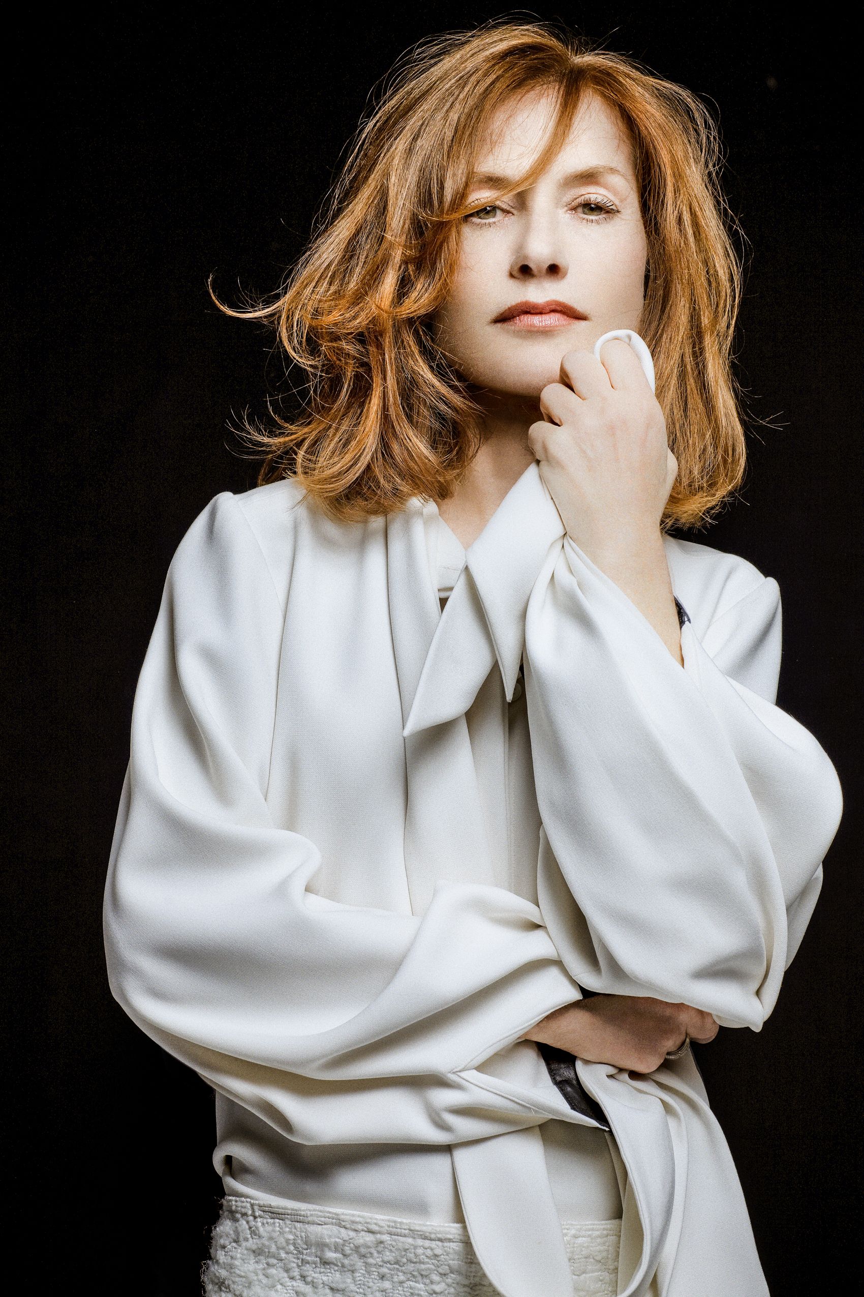 A series of artistic fashion portraits featuring a person in a white oversized shirt against a dark background.