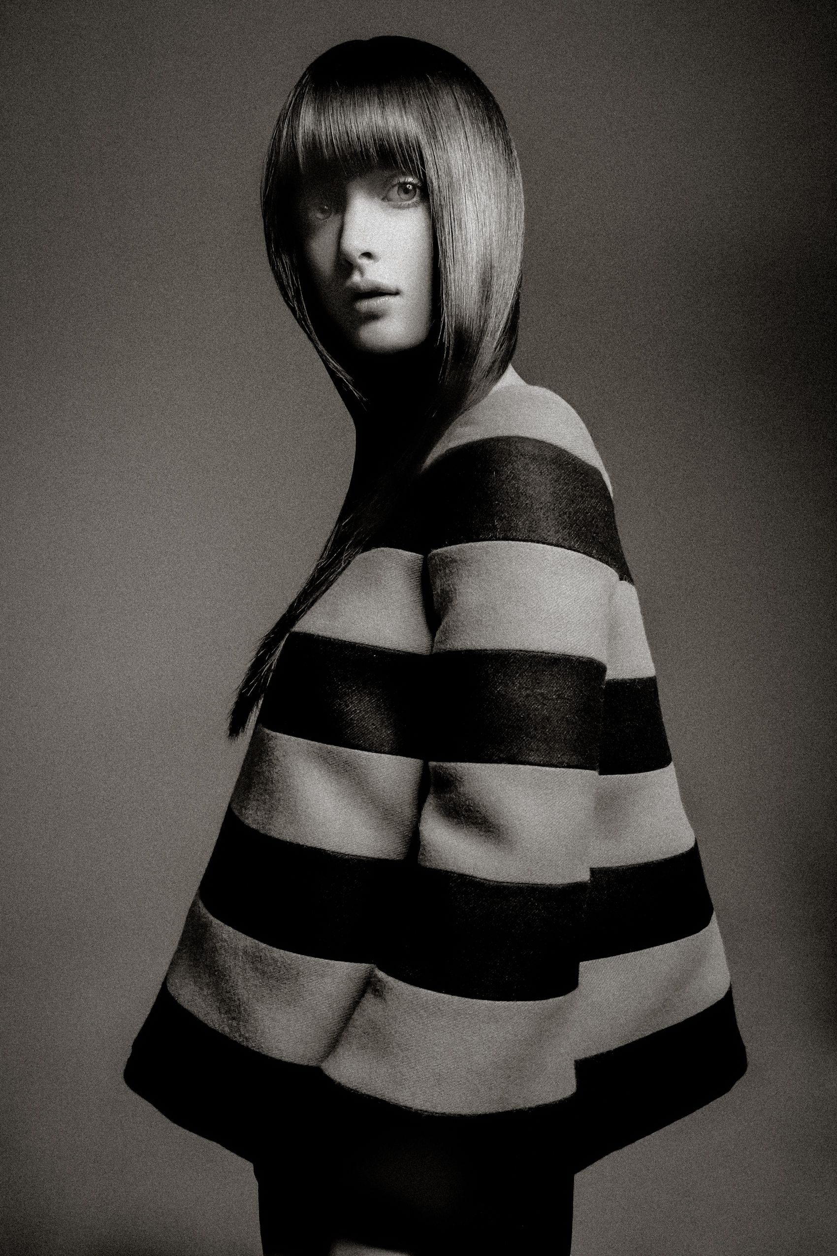 Artistic black and white fashion photo series showing model in striped off-shoulder design from different angles.