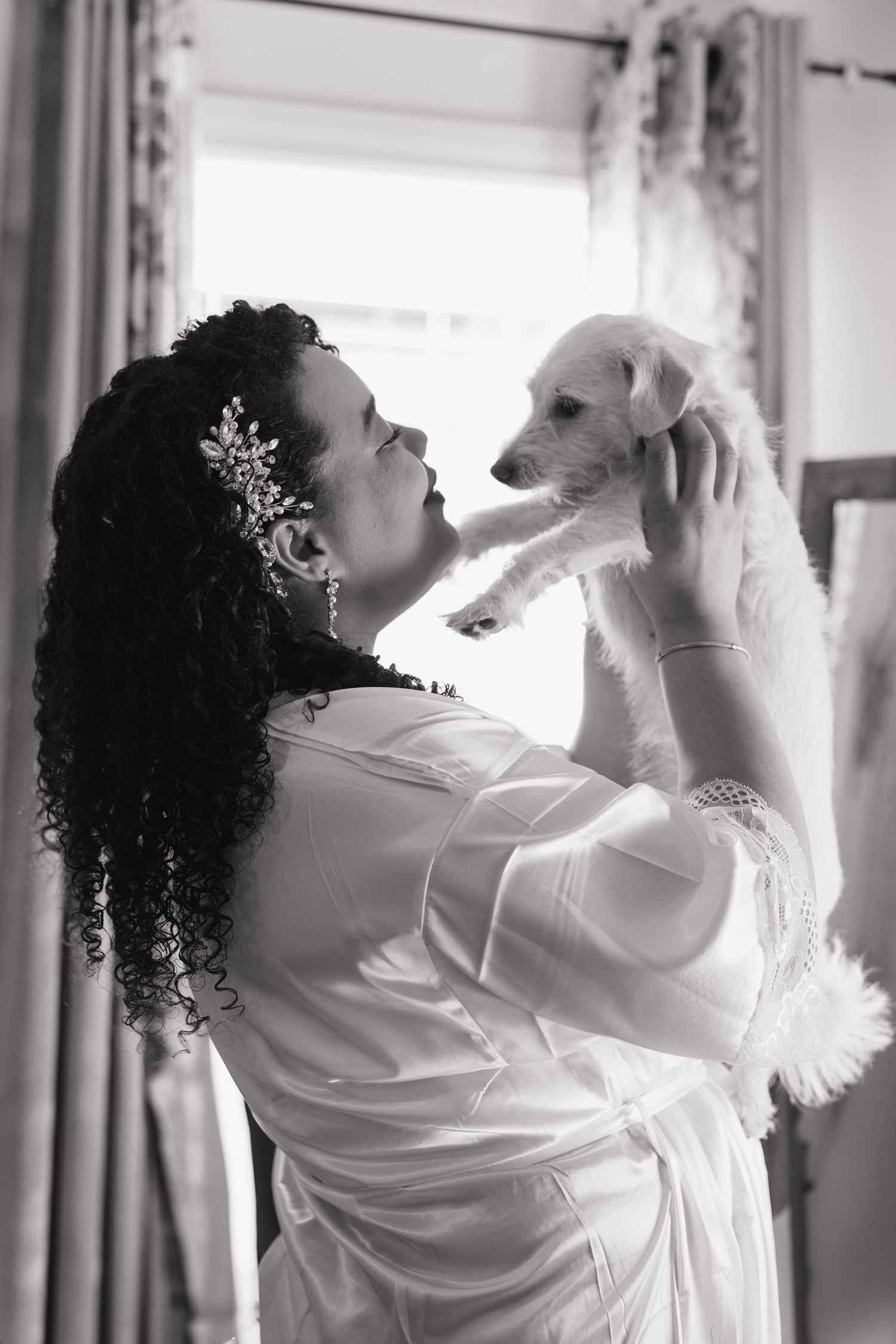 Black and white photo sequence showing a bride getting ready in a robe with curly hair and hair accessories.