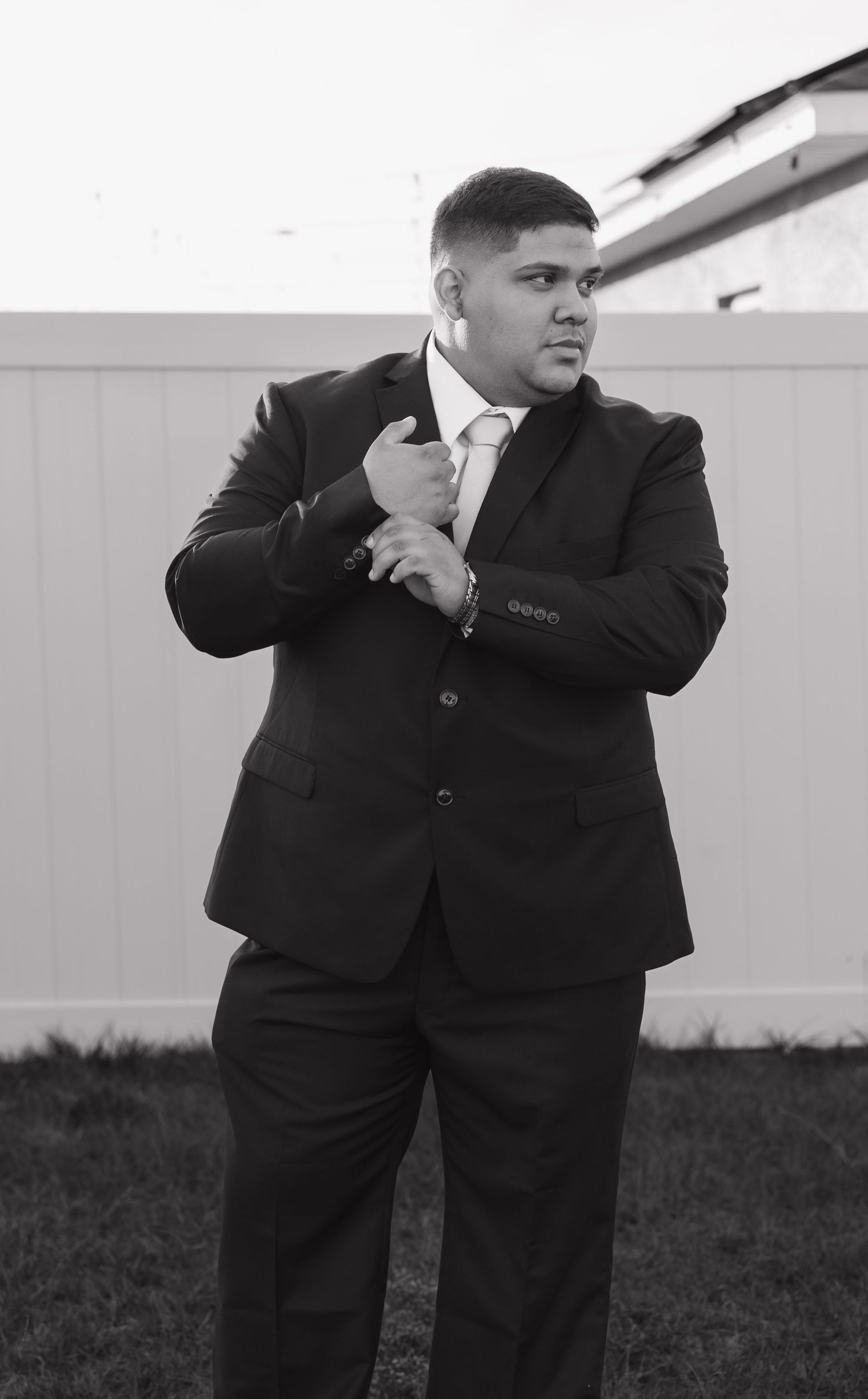 Series of black and white photos showing groomsmen in suits striking dramatic poses.