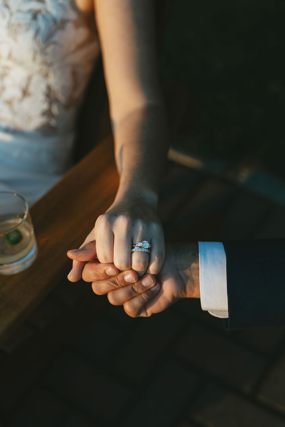 Close-up sequence of hands rolling white tape or bandage in dark moody lighting.