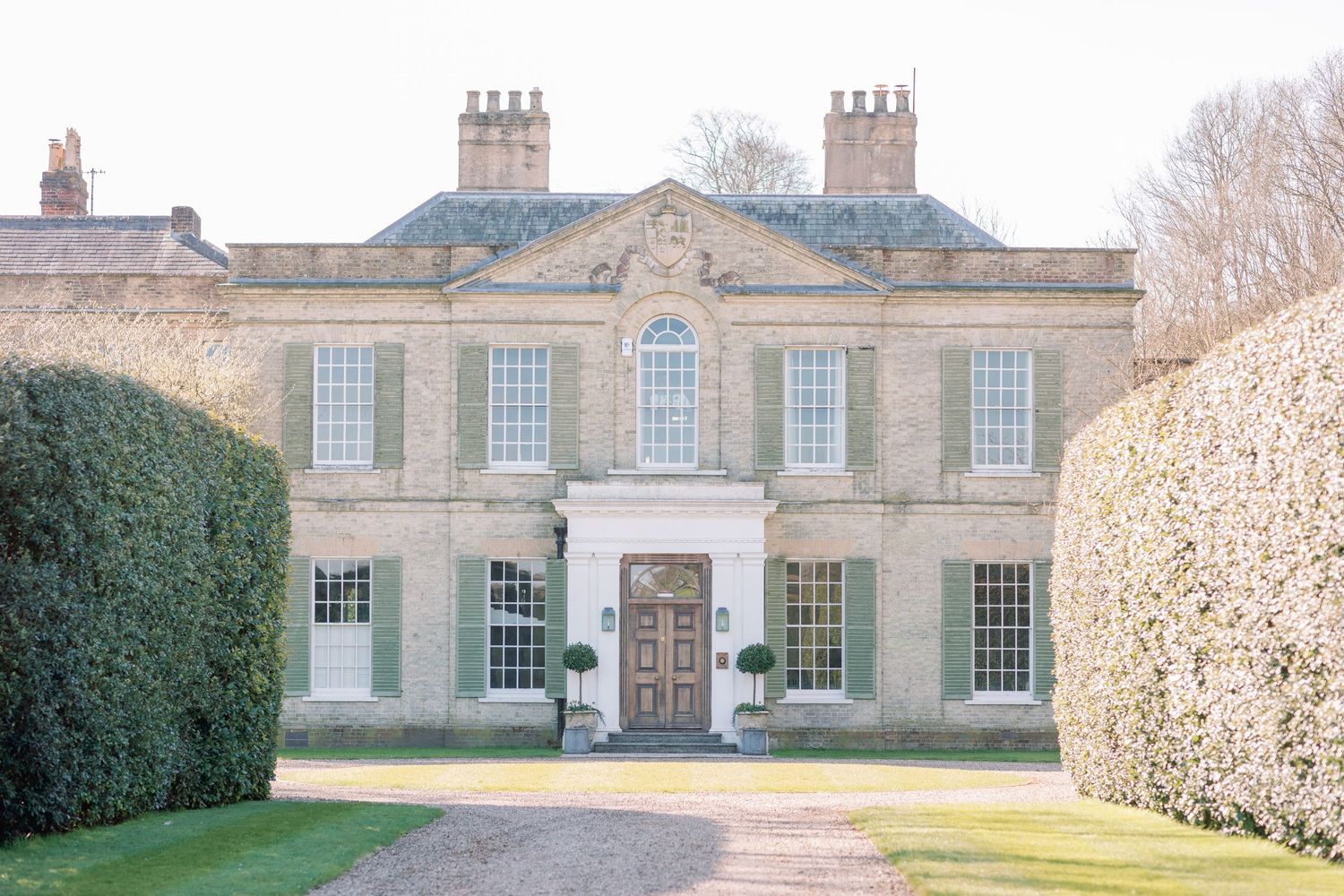 A series of connected images showing a grand English country manor house with symmetrical windows and stone architecture.