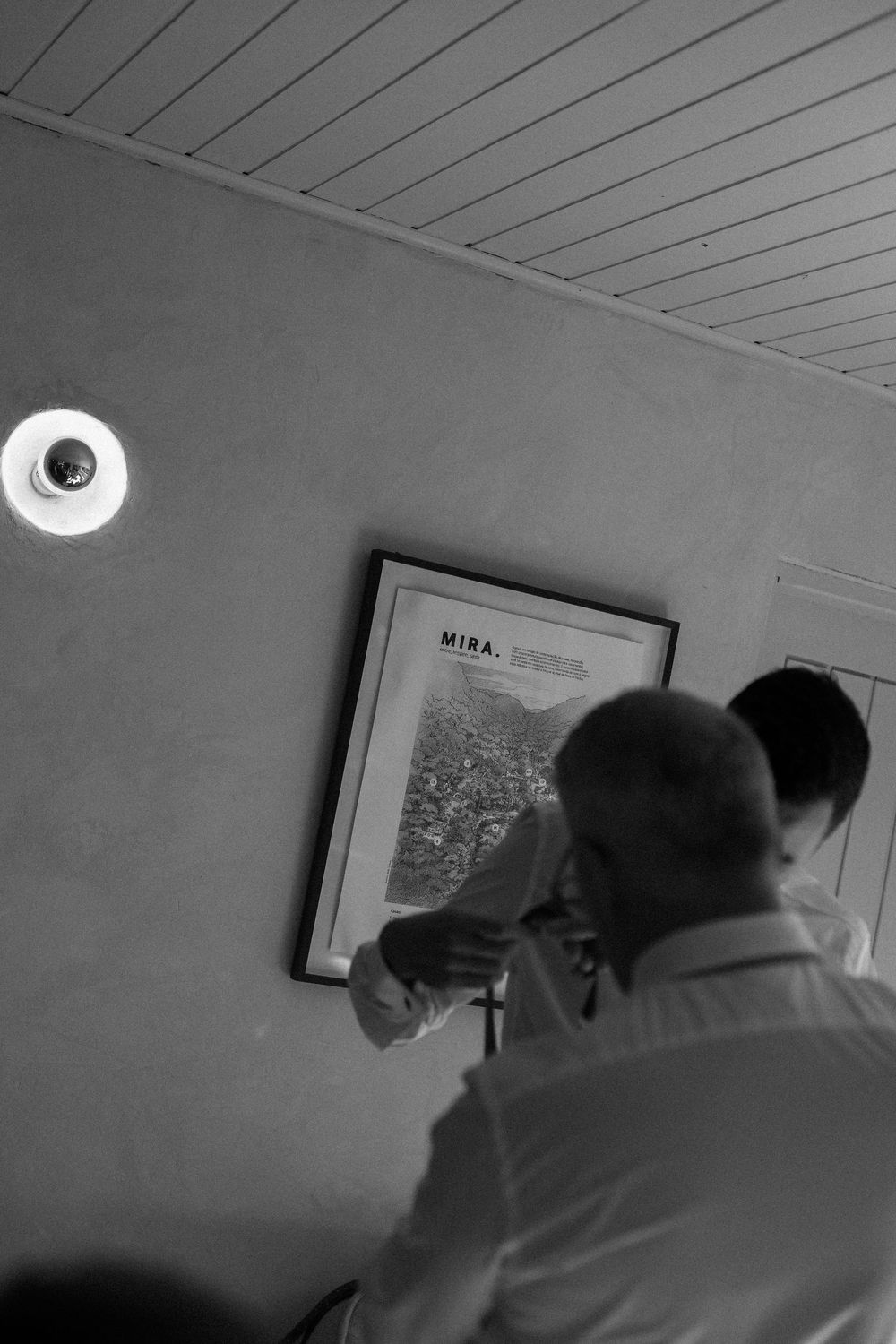 A series of black and white surveillance camera images showing motion in a dimly lit interior space.