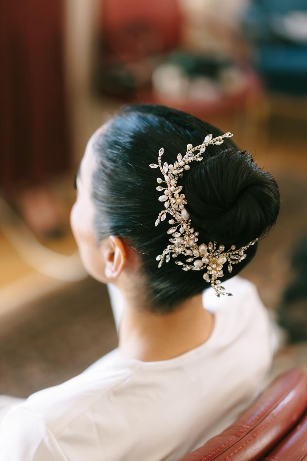 Elegant bridal hairstyle with delicate crystal hair accessory in an updo.