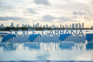 A panoramic series of waterfront views showing the Miami skyline and marina with boats against a cloudy sunset sky.