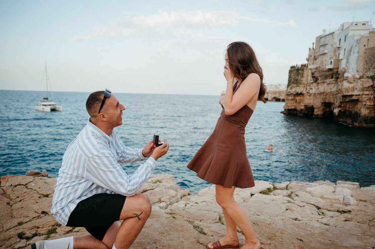 A series of photos showing a romantic marriage proposal on a rocky beach with cliffs and ocean in the background.