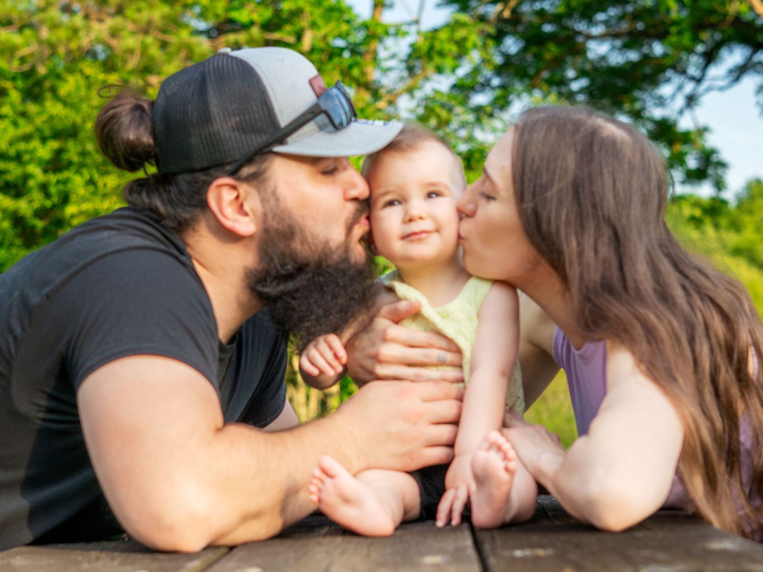 A series of romantic kissing photos captured outdoors in natural sunlight showing tender moments between couples.