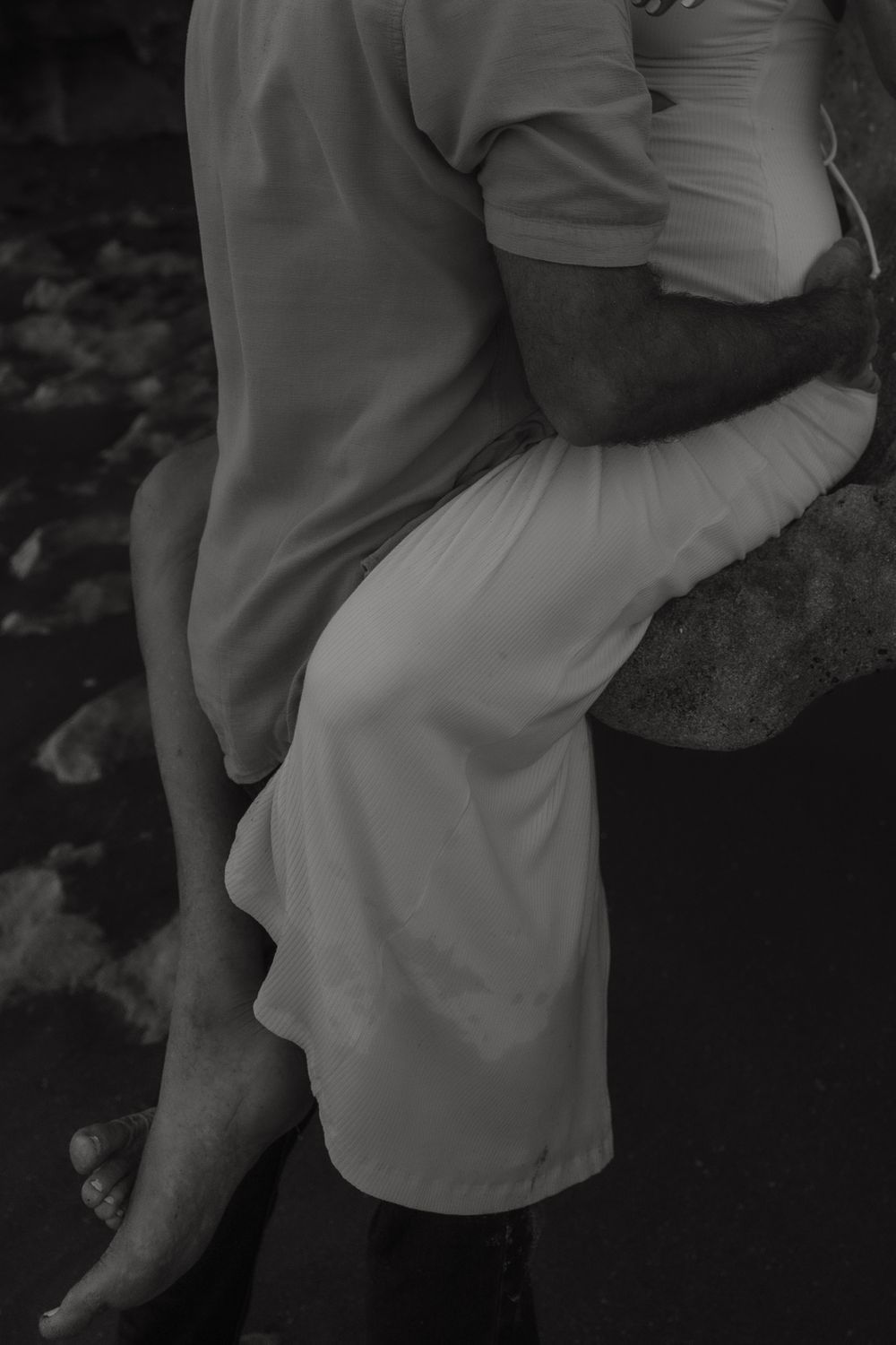 A romantic black and white photo series showing a couple embracing and dancing together in formal attire.