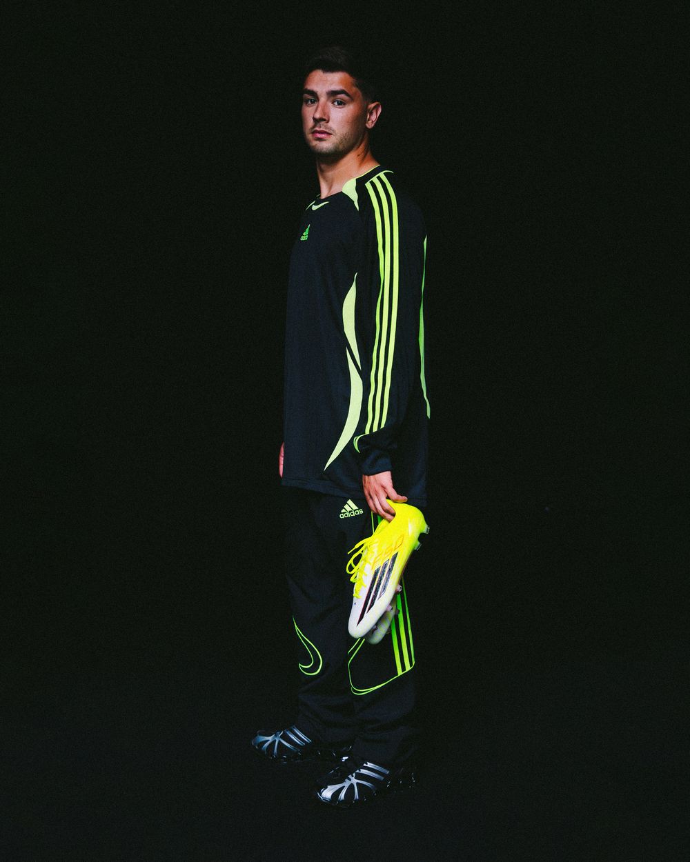 A figure in dark athletic wear with neon yellow accents poses against a black background in a series of dynamic shots.