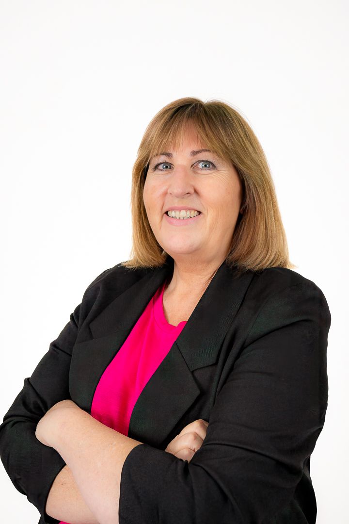 Professional headshots of someone in a black blazer and pink top showing different poses against a white background.