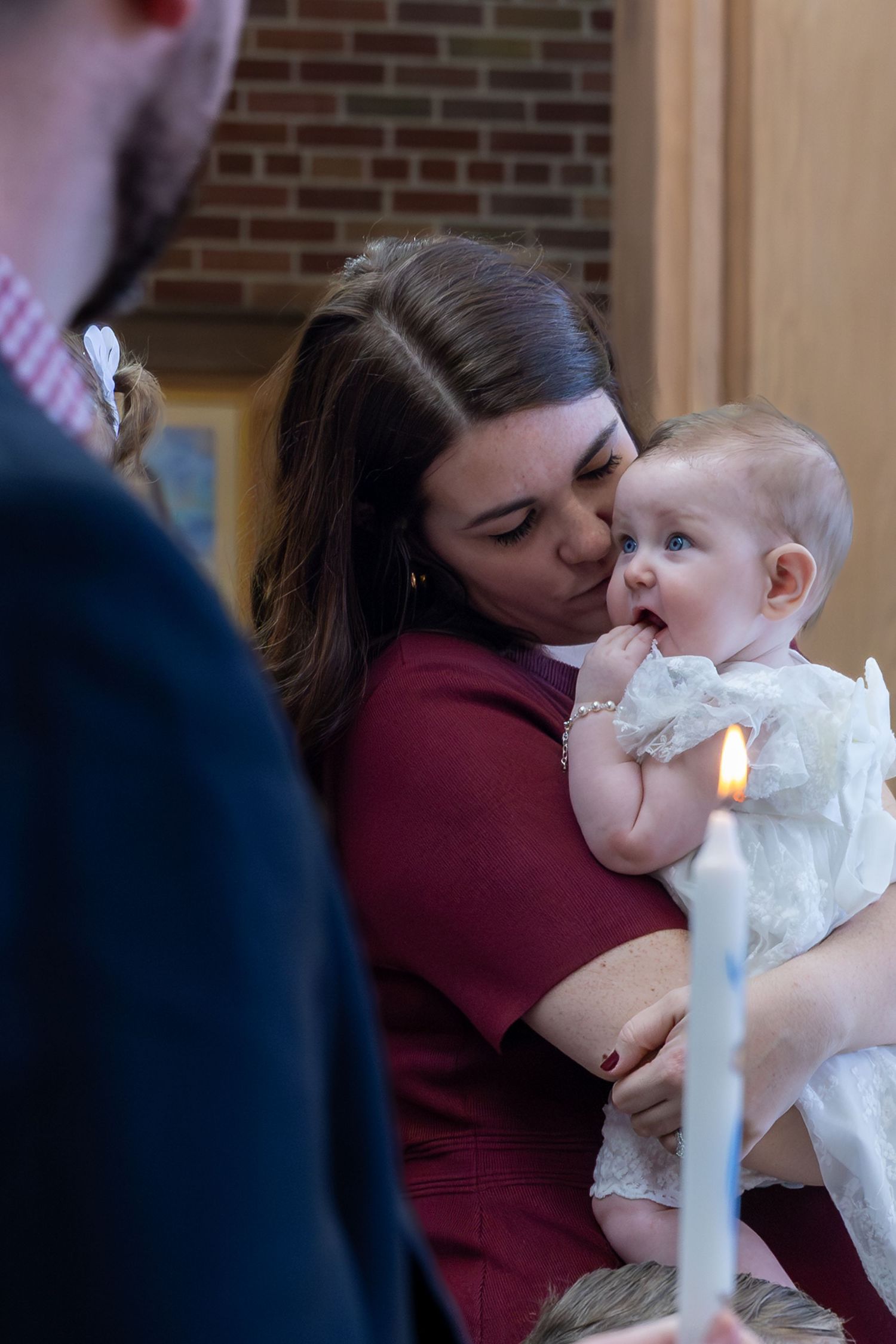 A baptism ceremony in progress with water being poured over at a church.