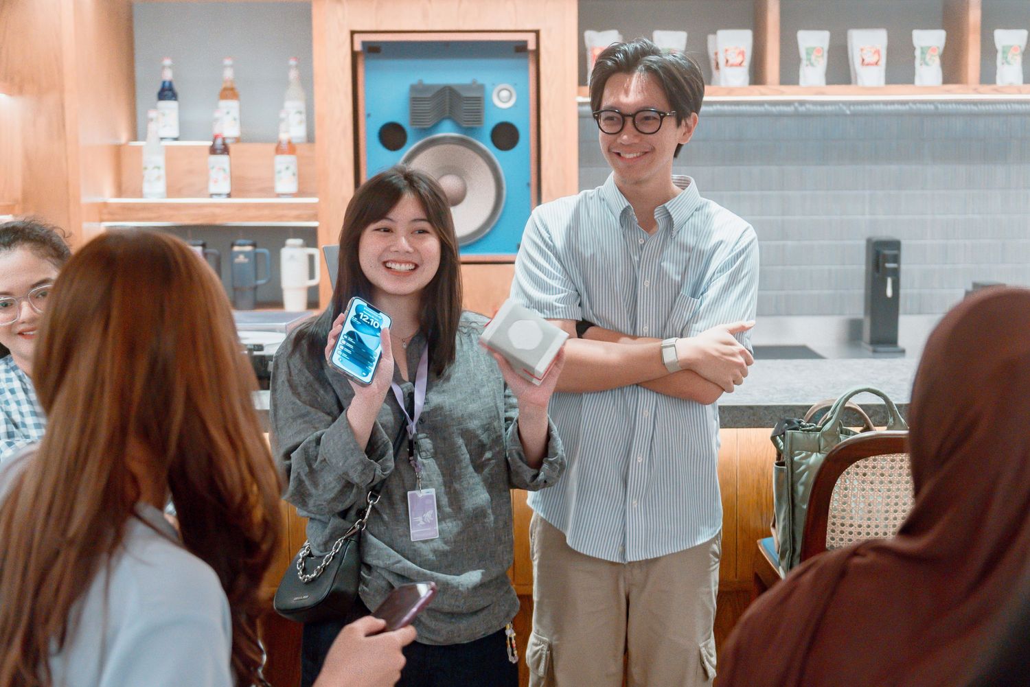 Students gather in a modern office space for a casual meeting or social event.