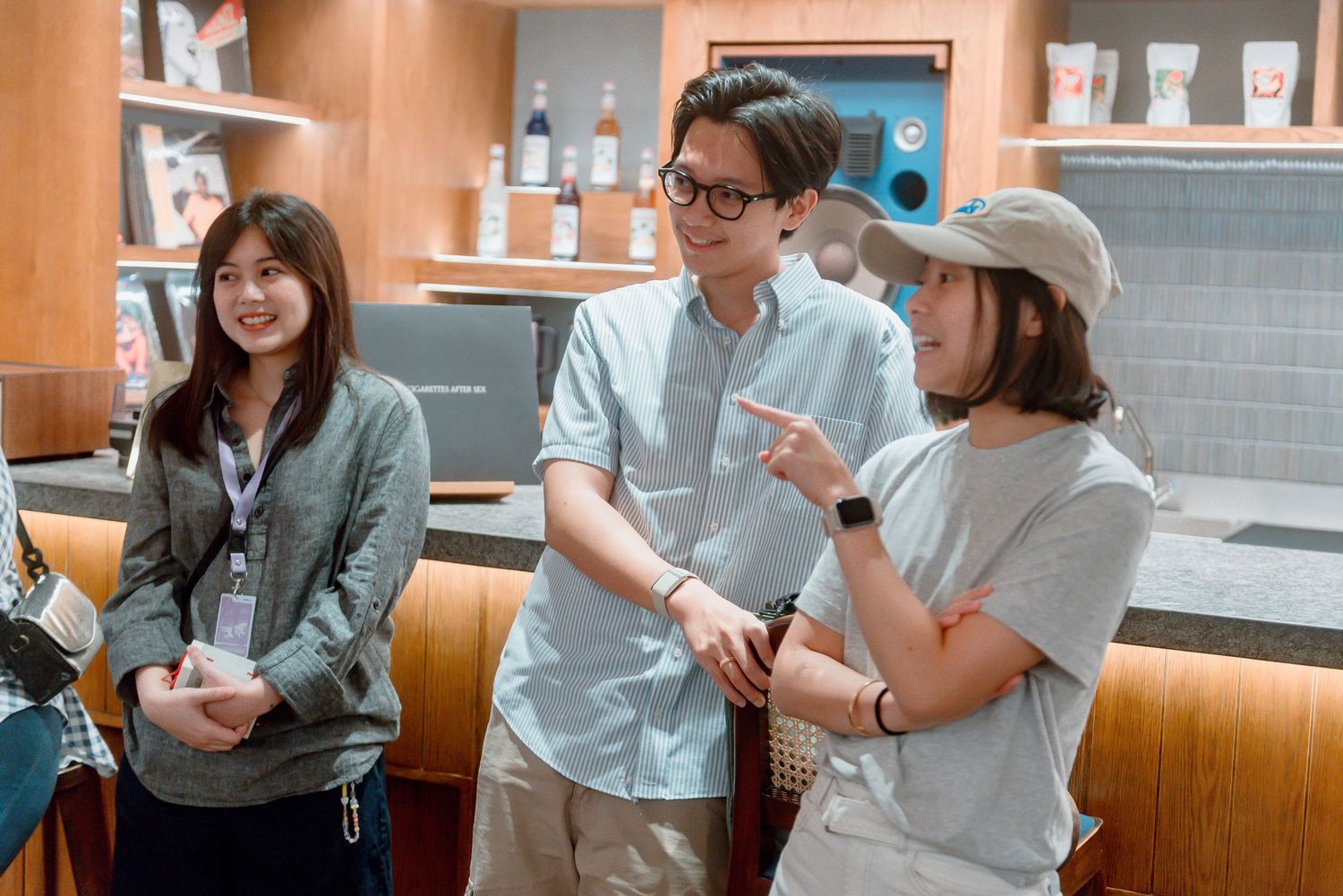 A group of people having a casual conversation while seated at a restaurant booth.