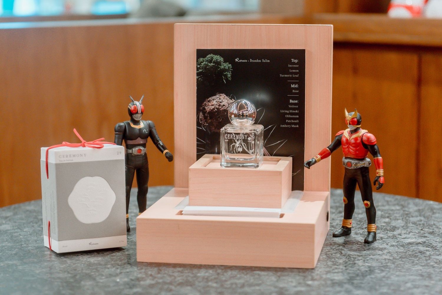 A row of small white boxes and retail displays arranged on a wooden surface in a store setting.