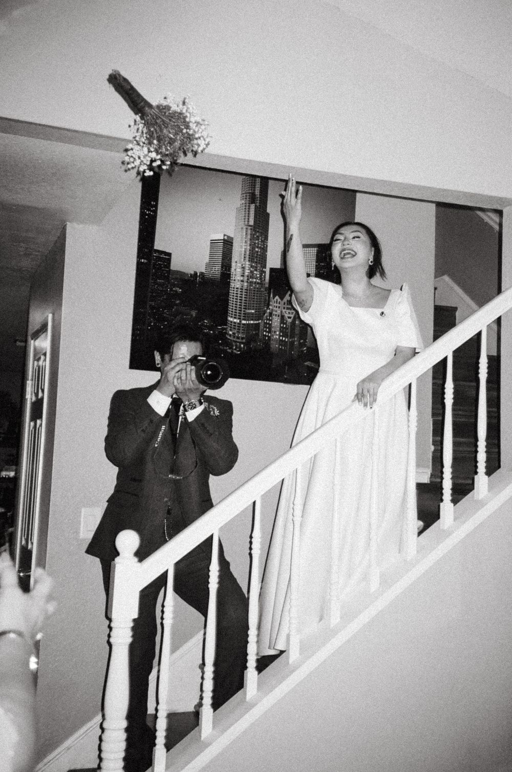 A series of black and white wedding photos showing people walking down a staircase in formal attire.