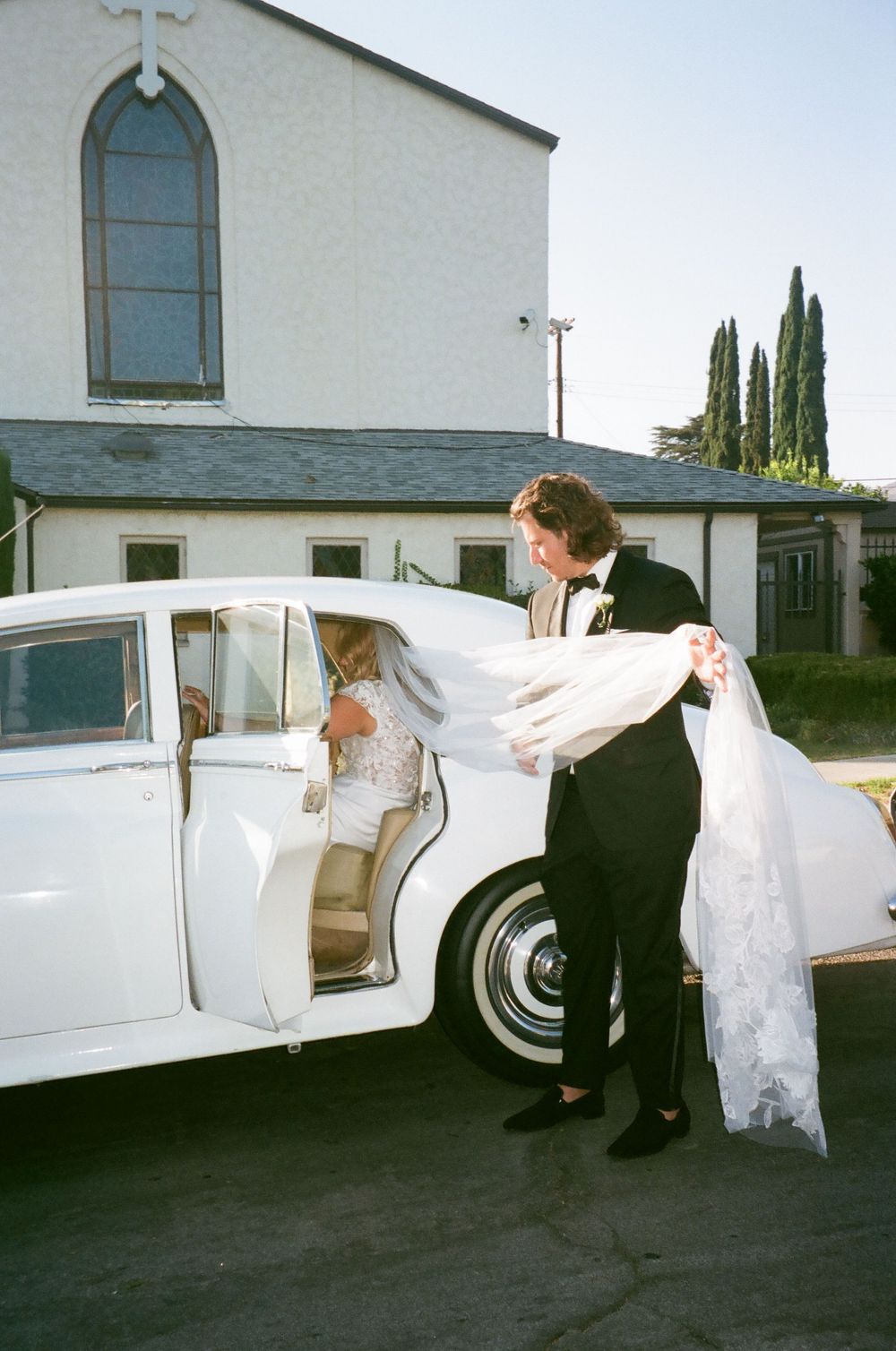 A sequence of photos showing a vintage white limousine parked outside a church building.