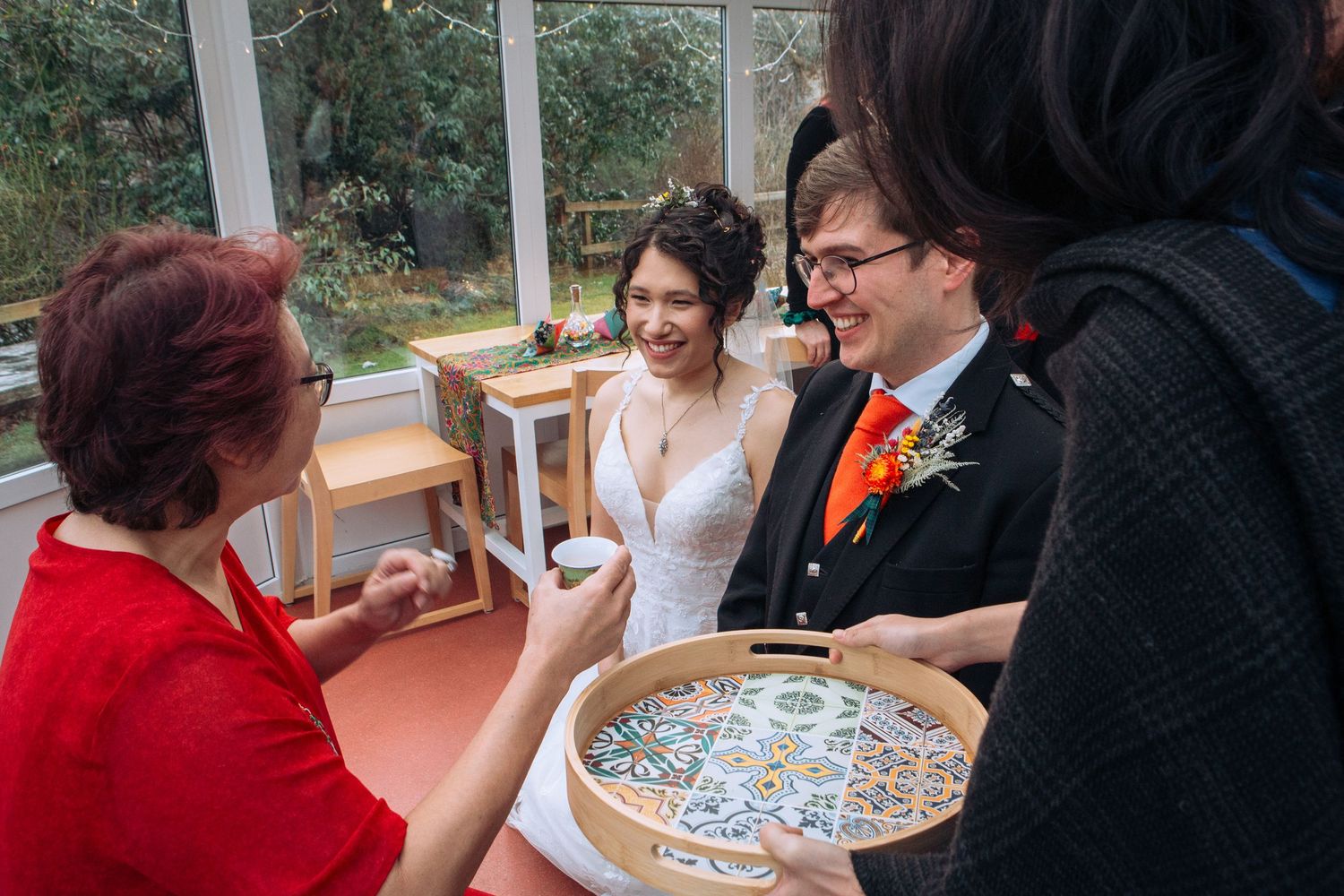 People gathered around a table playing a board game or card game in a social setting.