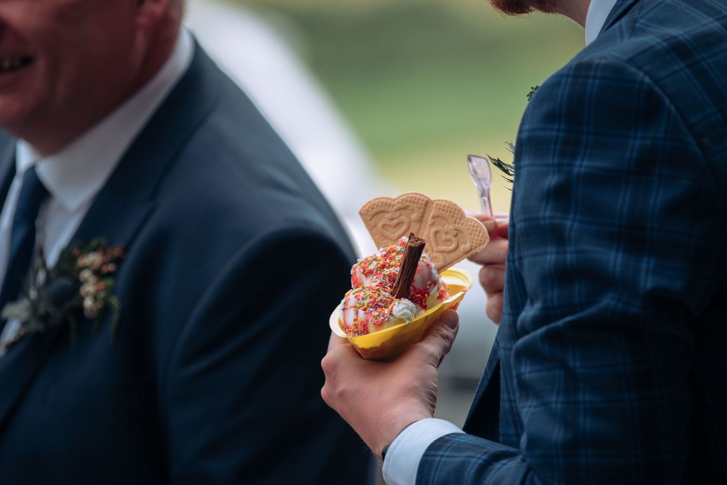 Wedding guests enjoy appetizers and drinks during an outdoor cocktail reception.