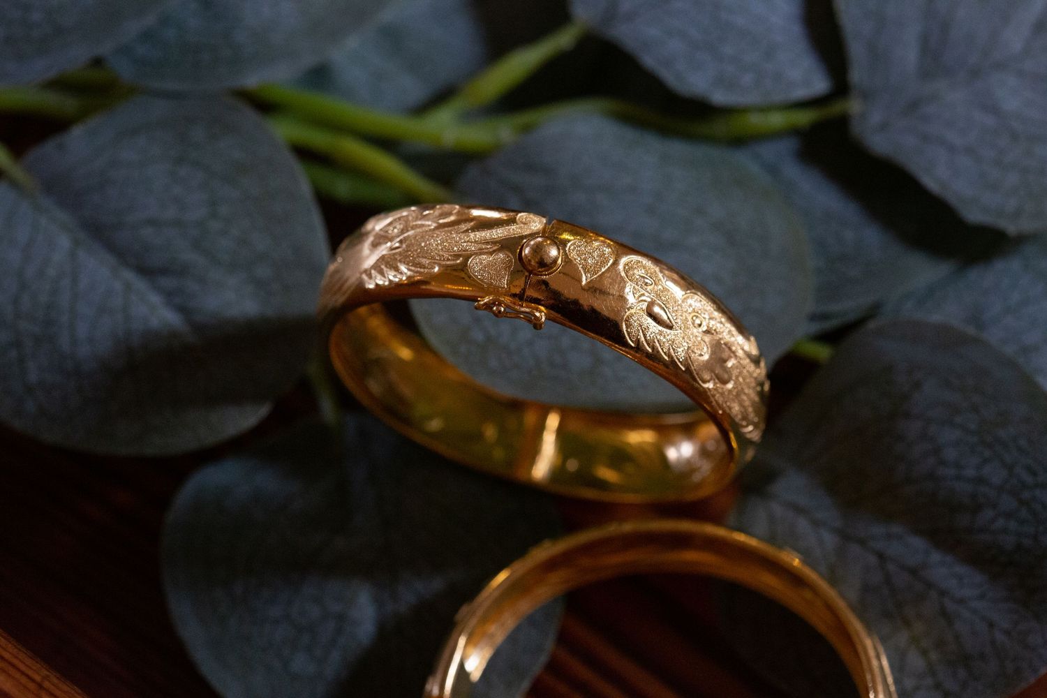 Close-up sequence showing the assembly of a gold engagement ring with a solitaire diamond setting.