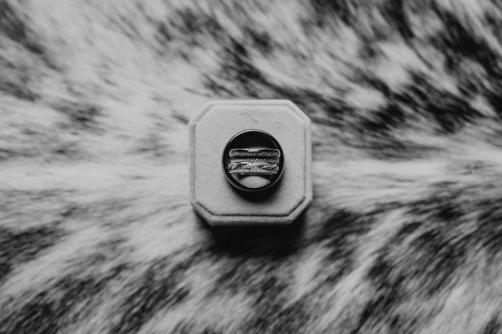 black and white image of wedding rings taken in Boone Iowa during a fall intimate wedding