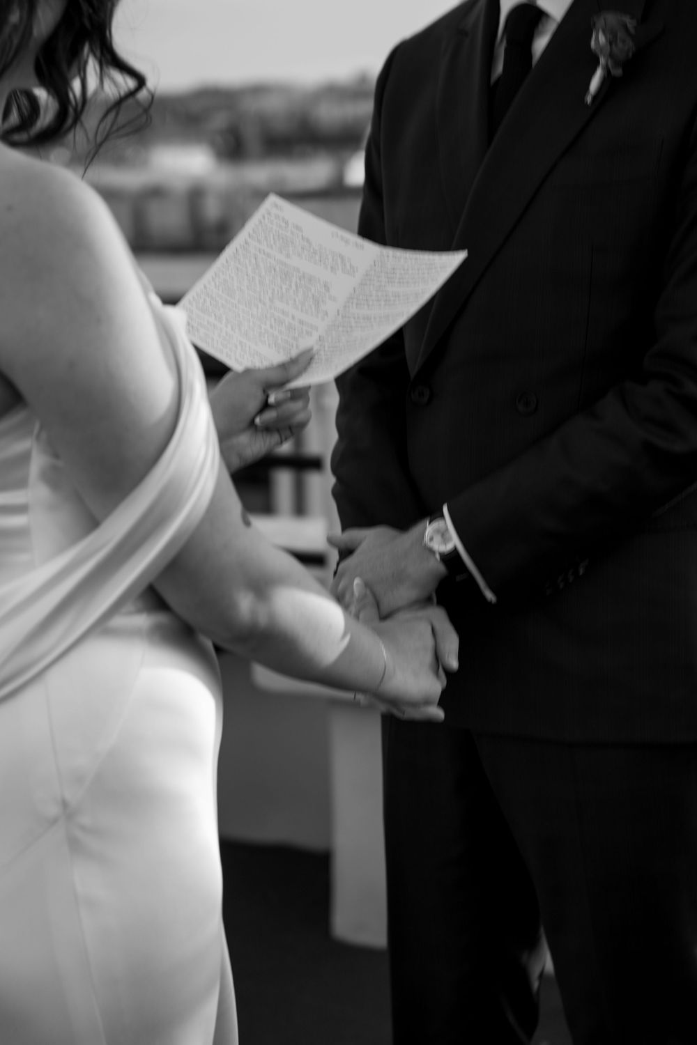 Wedding ceremony moment showing couple exchanging vows with white dress and formal attire.