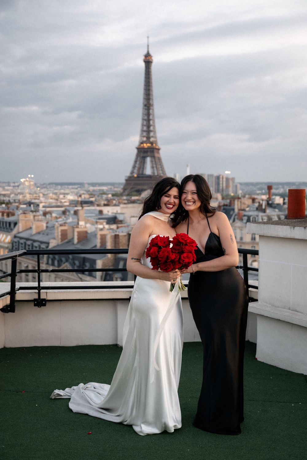 Scenic rooftop view of Paris with the Eiffel Tower visible in the background on a cloudy day.