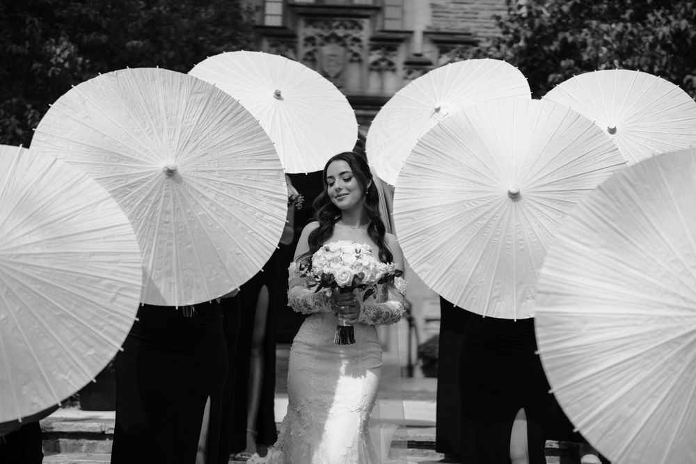 Black and white photo of a wedding ceremony in a traditional church with ornate altar decorations.