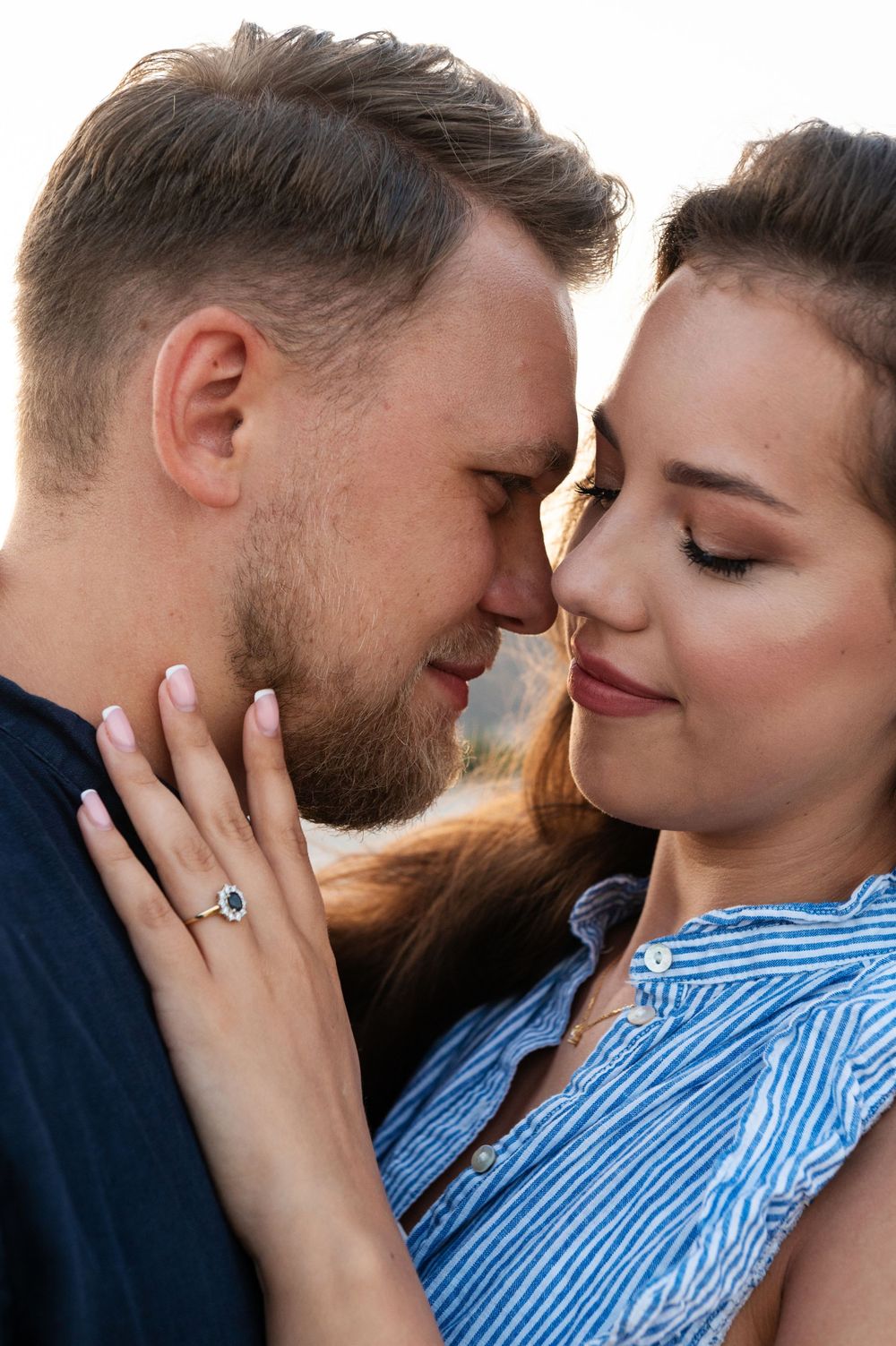 Intimate close-up moments of a couple during their beach engagement.