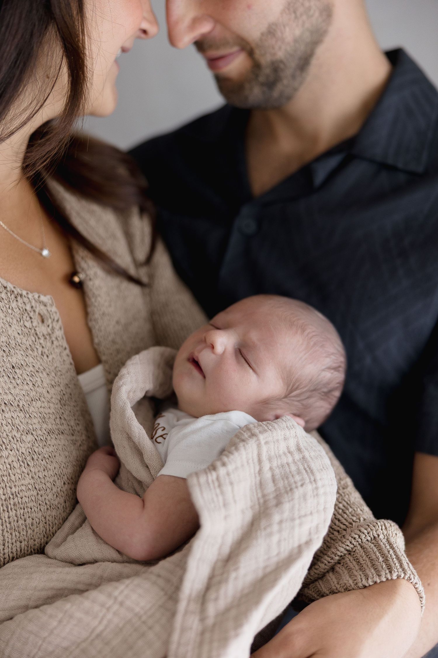Family studio photoshoot in Orange County with mom, dad, and newborn