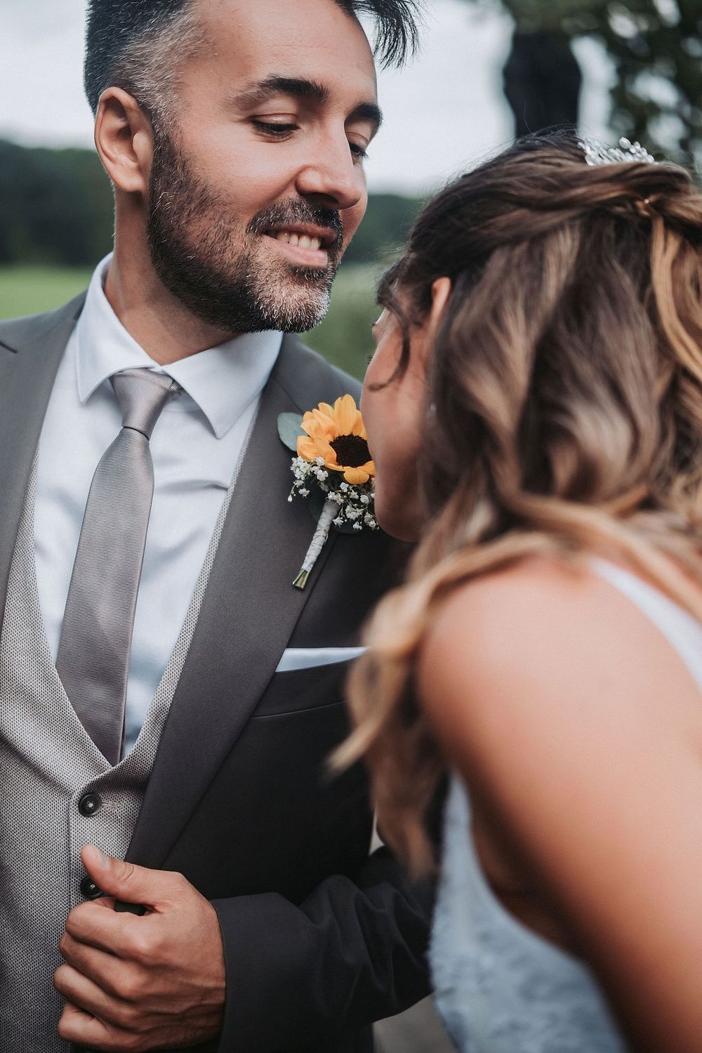 Intimate wedding couple shares tender moments in series of romantic black and white portraits with orange floral boutonniere.