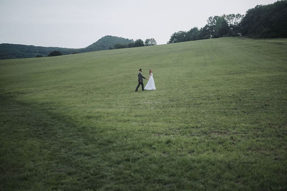 A series of scenic green hillside meadow photographs showing a small tent and figures in the distance.