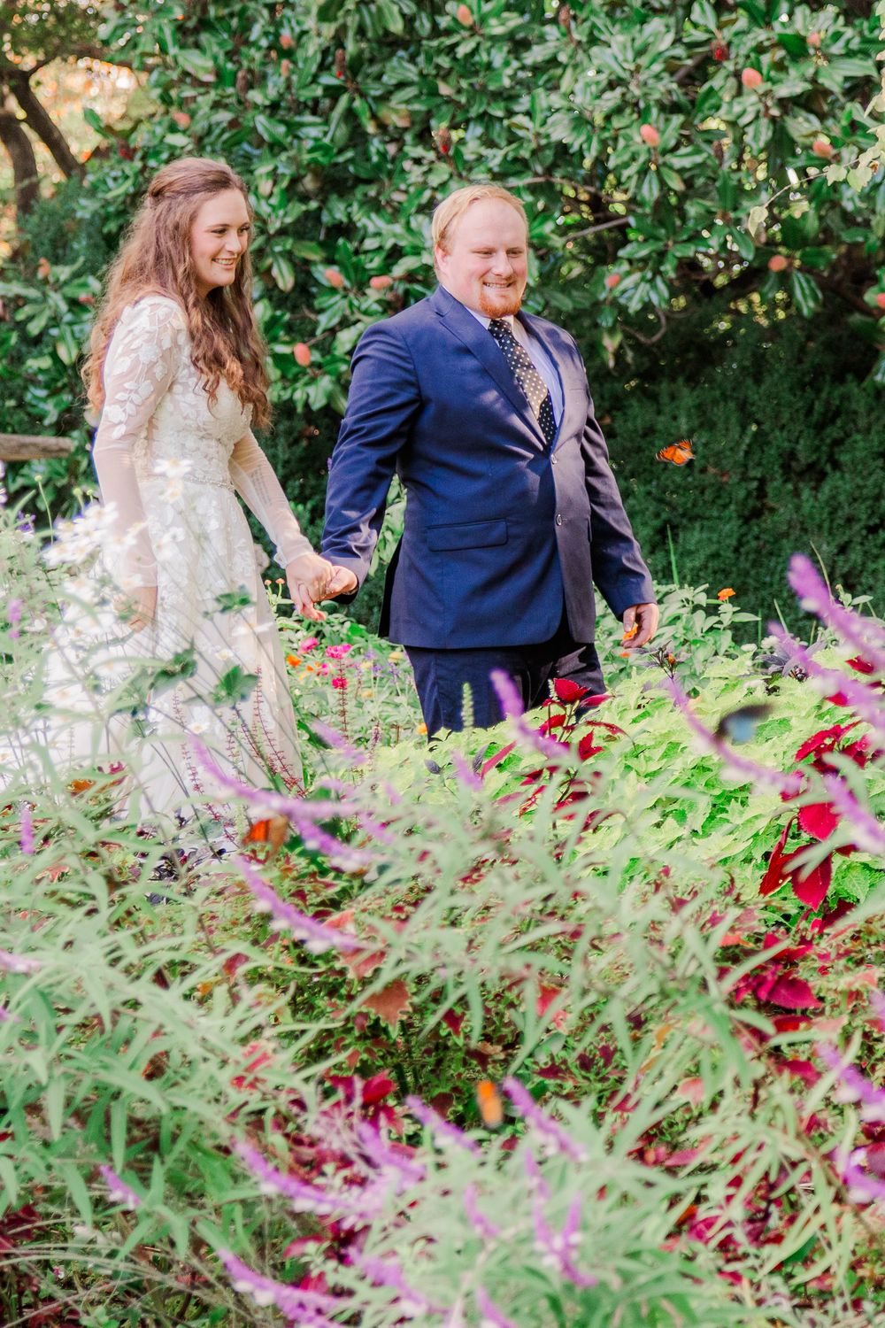 Bride and groom walking hand in hand through the gardens at Bartlett Arboretum during their one-year anniversary session.