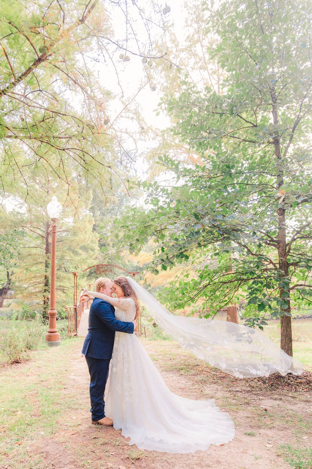 Romantic embrace under the trees during Bartlett Arboretum anniversary shoot