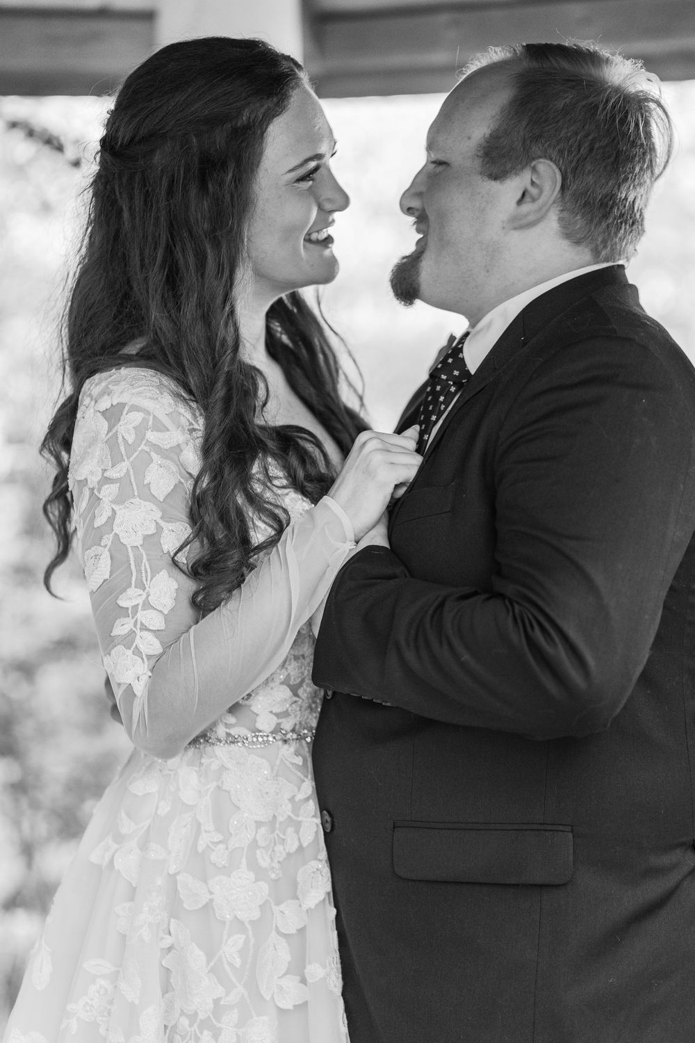 Bride laughing with her husband during morning anniversary portraits at Bartlett Arboretum.