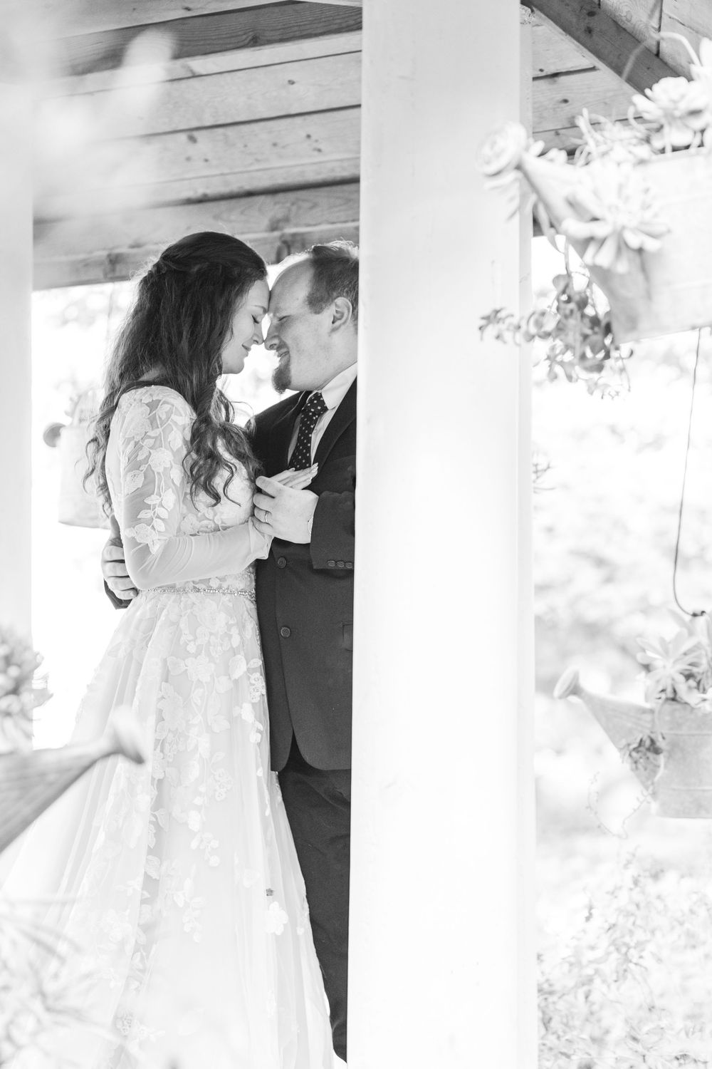Bride and groom smiling at each other in soft golden light during their anniversary photos.