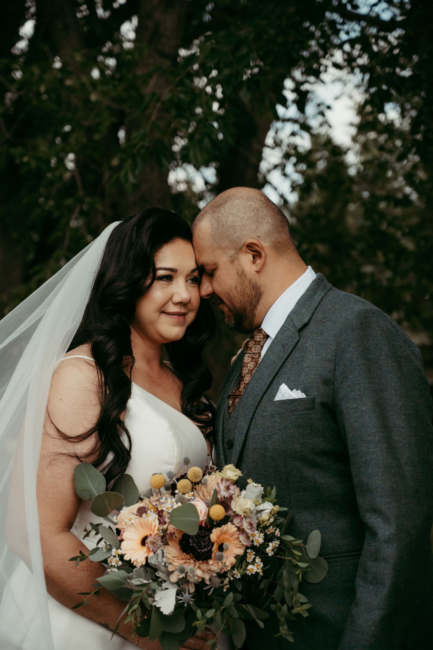 A romantic wedding moment captured in a series of photos showing the couple with a beautiful peach and white floral bouquet.