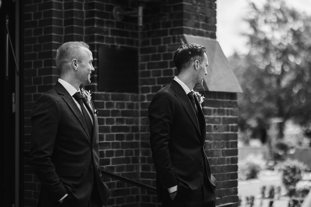 A black and white wedding photo collage showing formal moments and candid interactions between people in formal attire.
