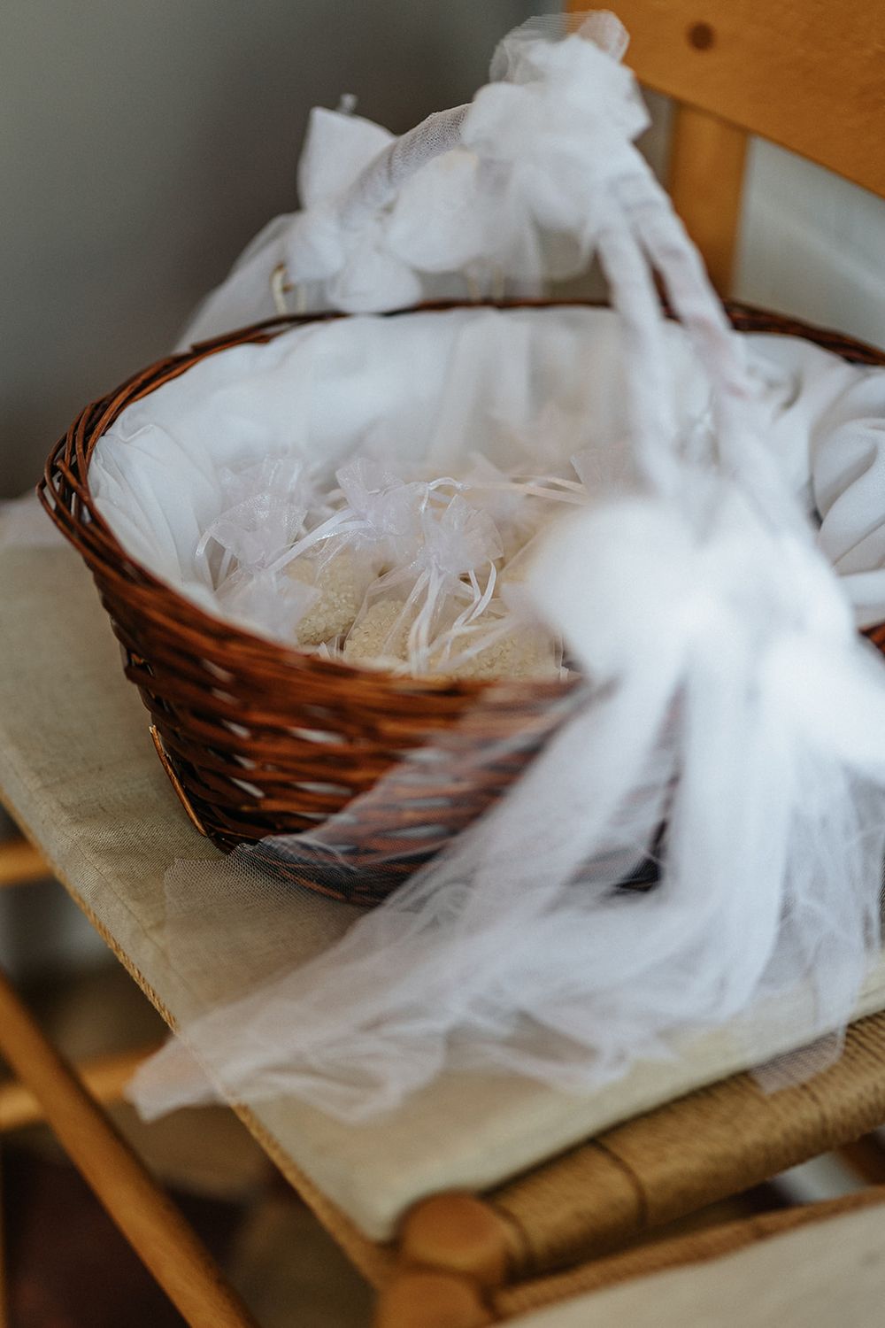 Cotton batting material is shown being pulled apart and arranged in a brown wicker basket.