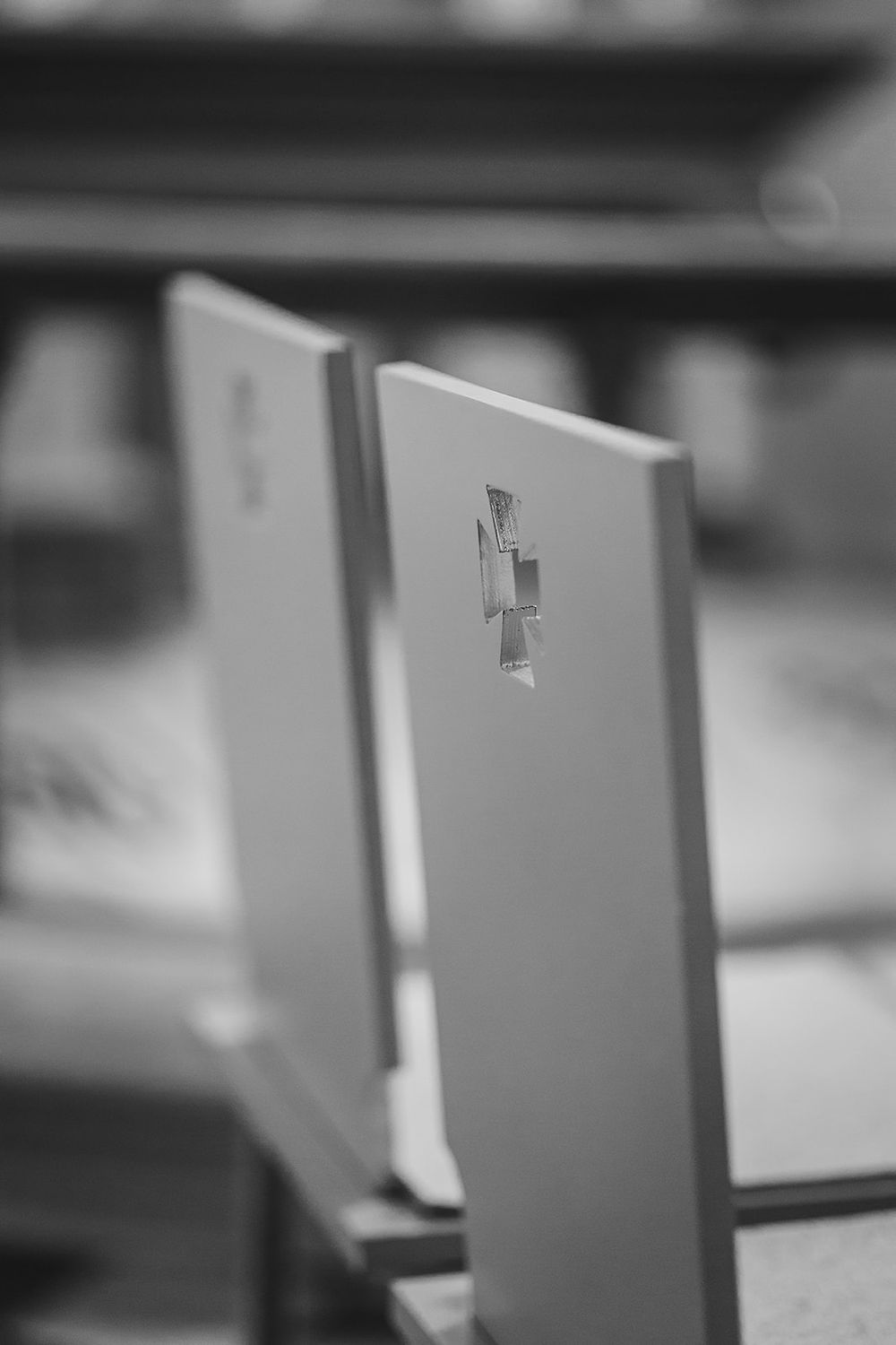 A series of white paper or card dividers arranged in a row with tabs, shown in black and white photography.