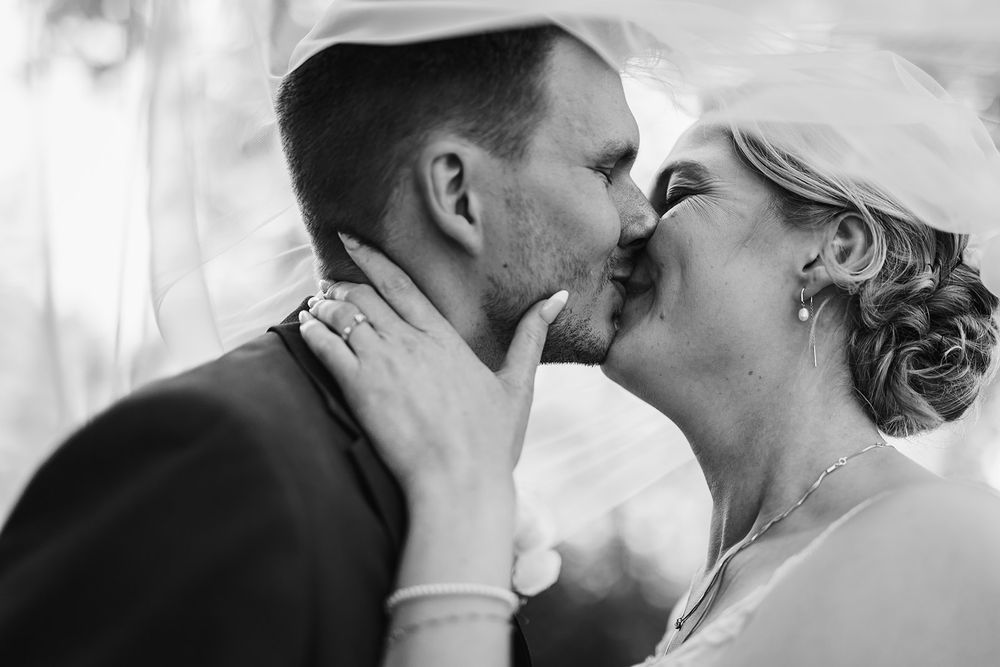 A series of romantic black and white photos showing couples kissing in intimate moments.