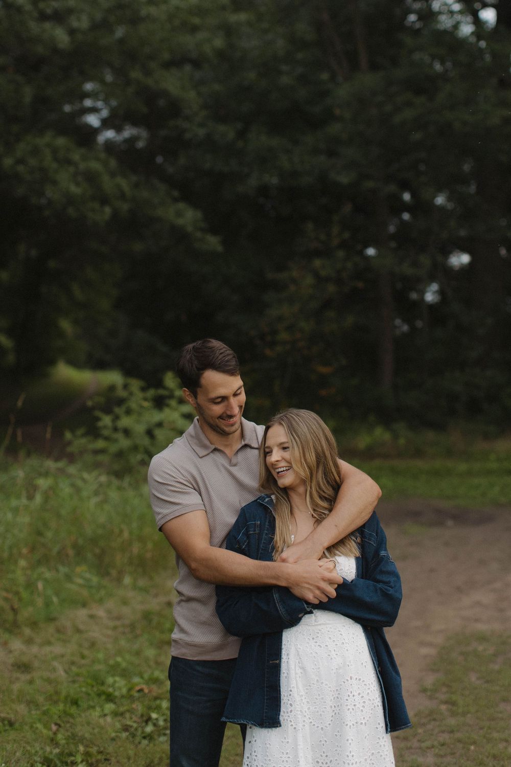 Couple sharing an intimate moment on a nature trail.
