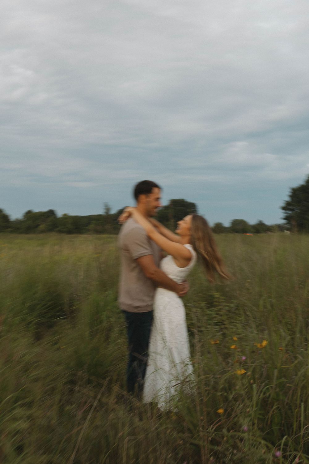 Romantic moment captured in a wild grass field.