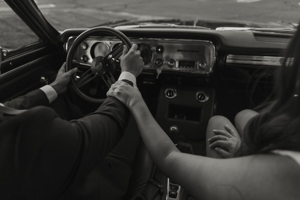 Interior view of a vintage car dashboard showing classic gauges and controls in black and white.