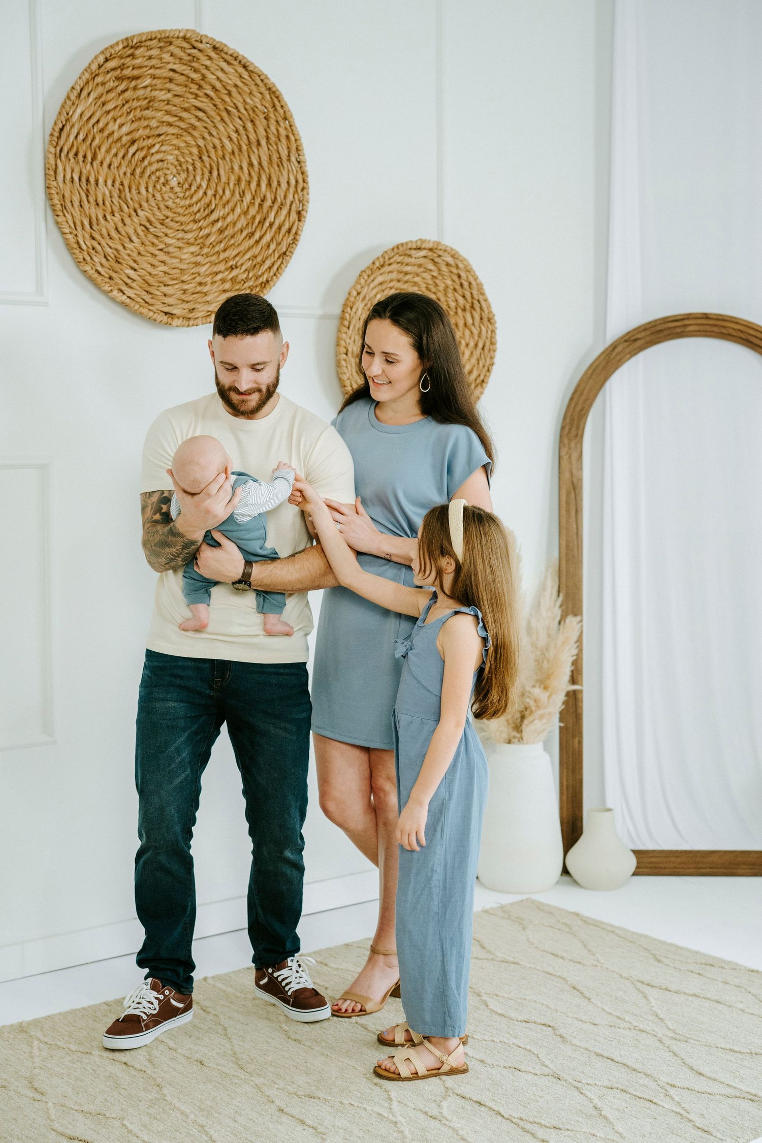 Candid lifestyle moments captured against white walls with decorative woven baskets as wall art.